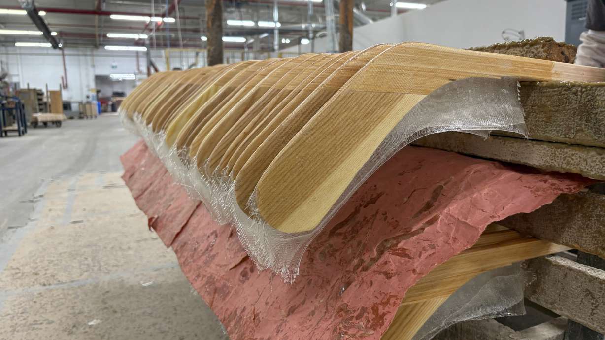 Wooden hockey sticks are stacked as they move along the assembly line at the Roustan Hockey factory, which is the last major manufacturer of hockey sticks in Canada on Aug. 27, 2025 in Brantford, Ontario.