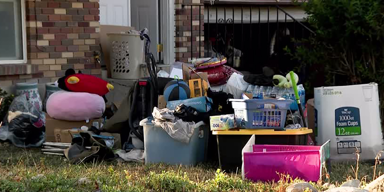 The Ly family's belongings are shown outside their water-damaged home on Sunday after historic rain caused major flooding in their Rose Park neighborhood.