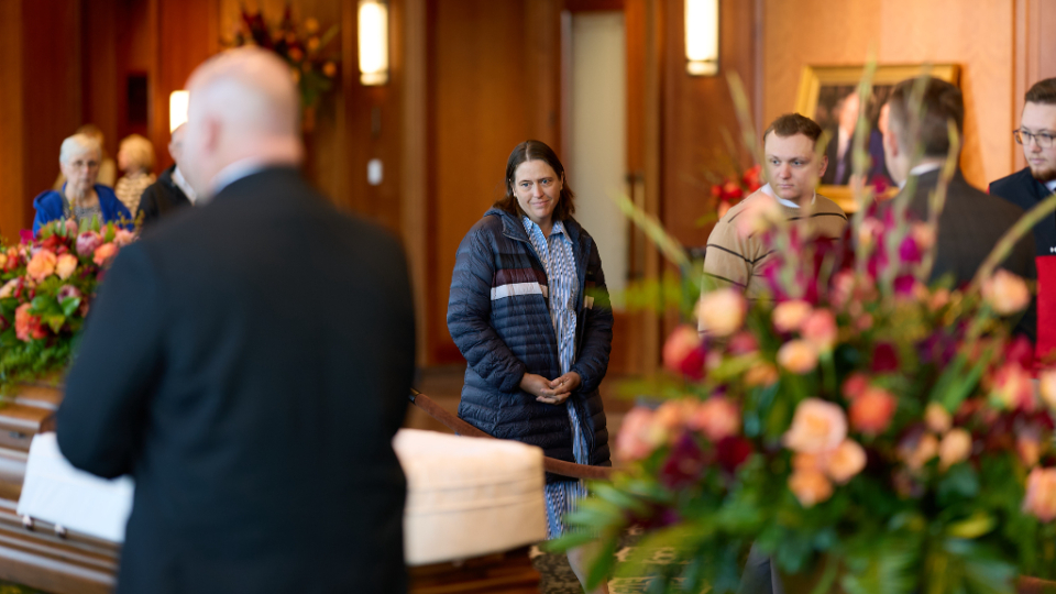 A woman pays her respects to the late President Russell M. Nelson in the Hall of the Prophets in the Conference Center of The Church of Jesus Christ of Latter-day Saints on Monday.