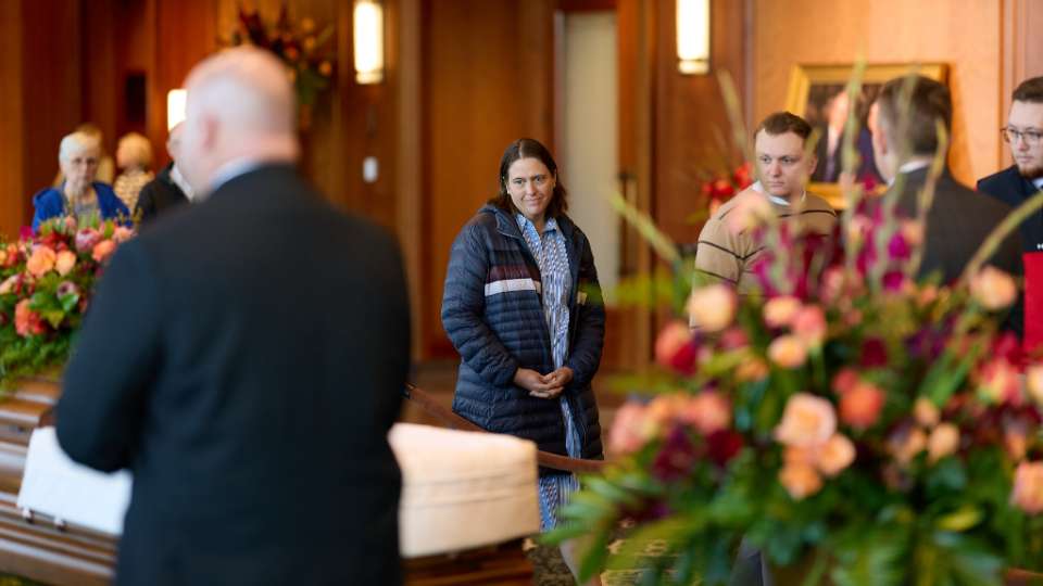 A woman pays her respects to the late President Russell M. Nelson in the Hall of the Prophets in the Conference Center of The Church of Jesus Christ of Latter-day Saints on Monday.