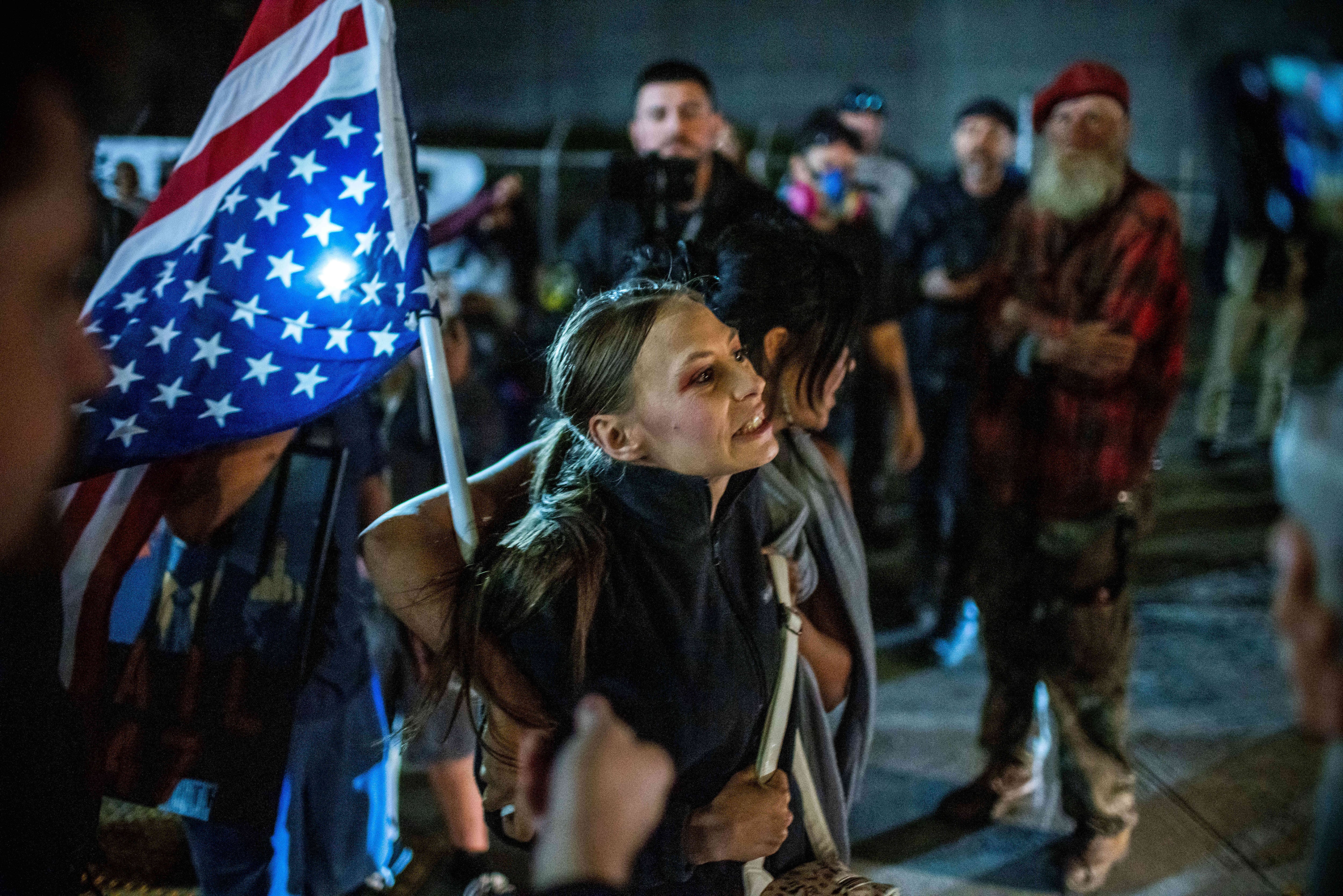 Protesters stand off against police and federal officers at the U.S. Immigration and Customs Enforcement facility in Portland, Ore., on Sunday.