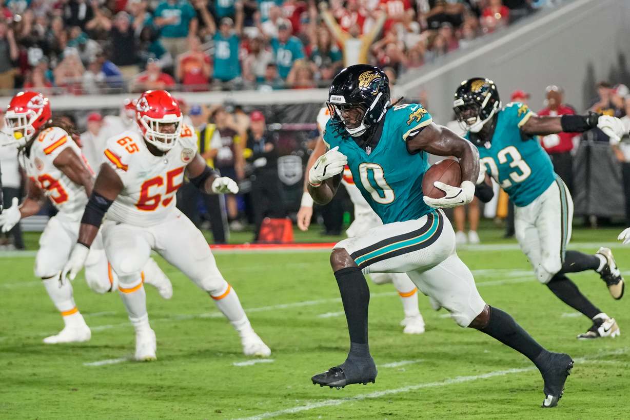 Jacksonville Jaguars linebacker Devin Lloyd (0) runs the ball 99 yards for a touchdown after intercepting a pass during the second half of an NFL football game against the Kansas City Chiefs, Monday, Oct. 6, 2025, in Jacksonville, Fla.