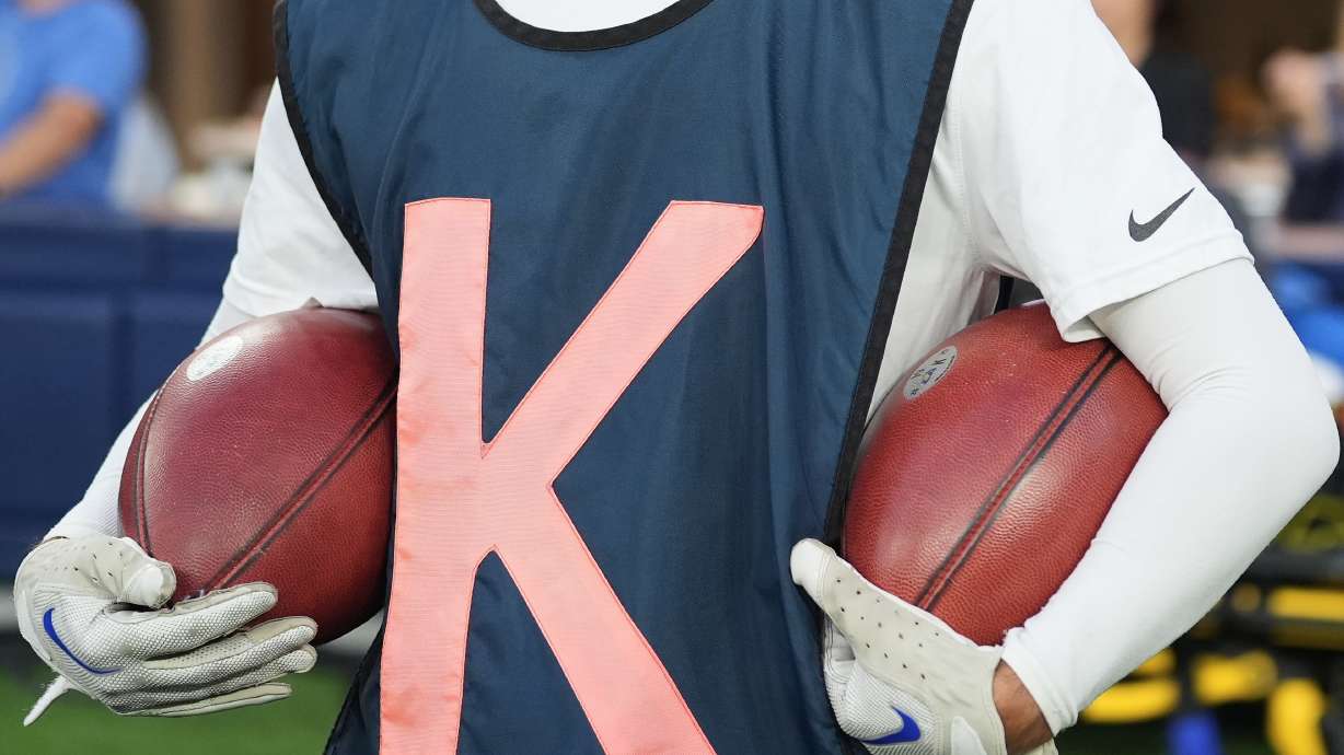 Special footballs used for kicks and punts are held by a ball crew member during the first half of an NFL football game between the Los Angeles Rams and the San Francisco 49ers, Thursday, Oct. 2, 2025, in Inglewood, Calif.