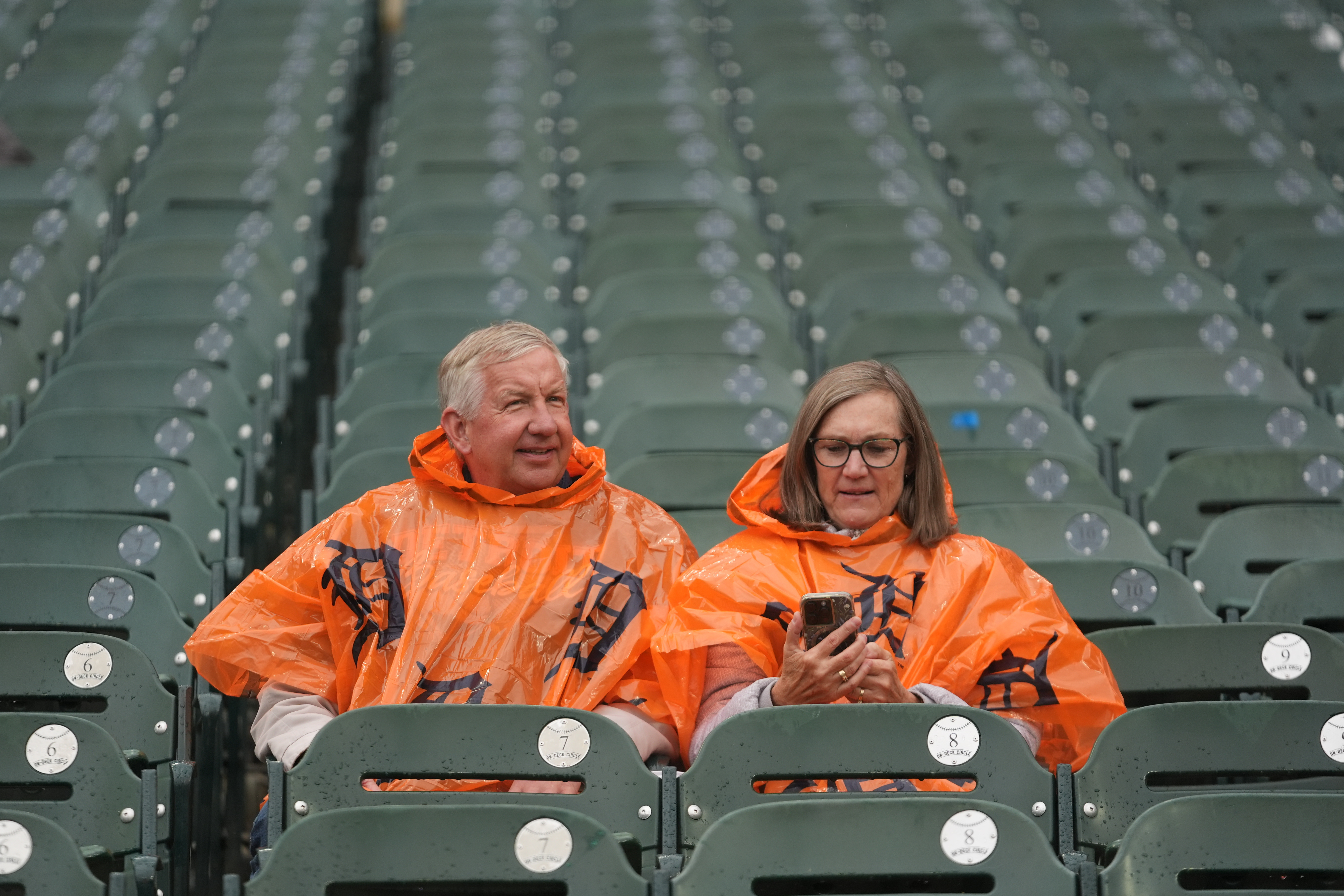 Fans sit in the stands as drizzle falls while waiting for the start of Game 3 of baseball's American League Division Series between the Detroit Tigers and the Seattle Mariners Tuesday, Oct. 7, 2025, in Detroit. 