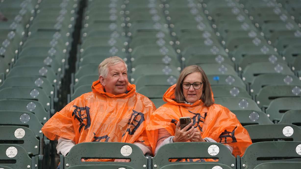 Fans sit in the stands as drizzle falls while waiting for the start of Game 3 of baseball's American League Division Series between the Detroit Tigers and the Seattle Mariners Tuesday, Oct. 7, 2025, in Detroit.