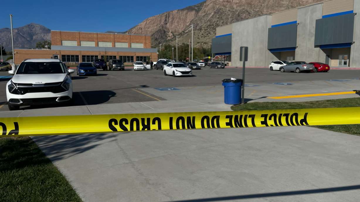 Police tape blocks the athletic complex at Ben Lomond High School in Ogden, preventing public entry while law enforcement officers investigate a shooting on Oct. 7. The father of one of the teens arrested is now facing criminal charges.