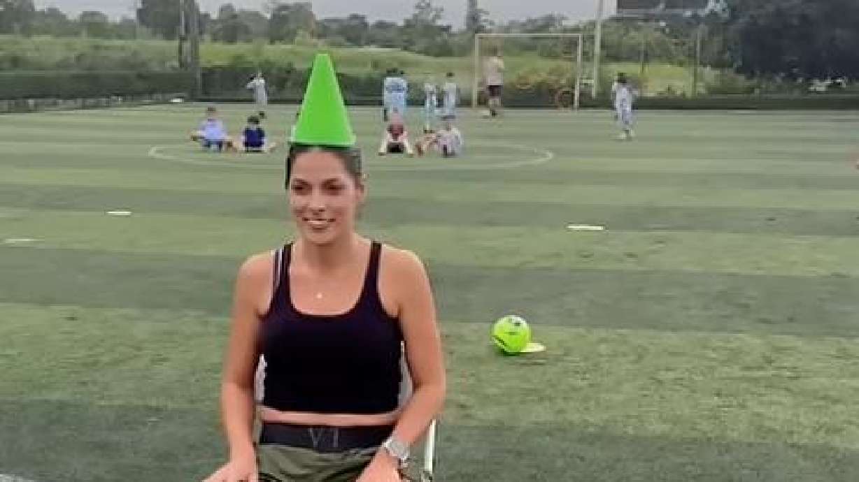 A child is tasked with kicking a cone off his mother's head on Sept. 9 in Limon, Guapiles, Costa Rica.