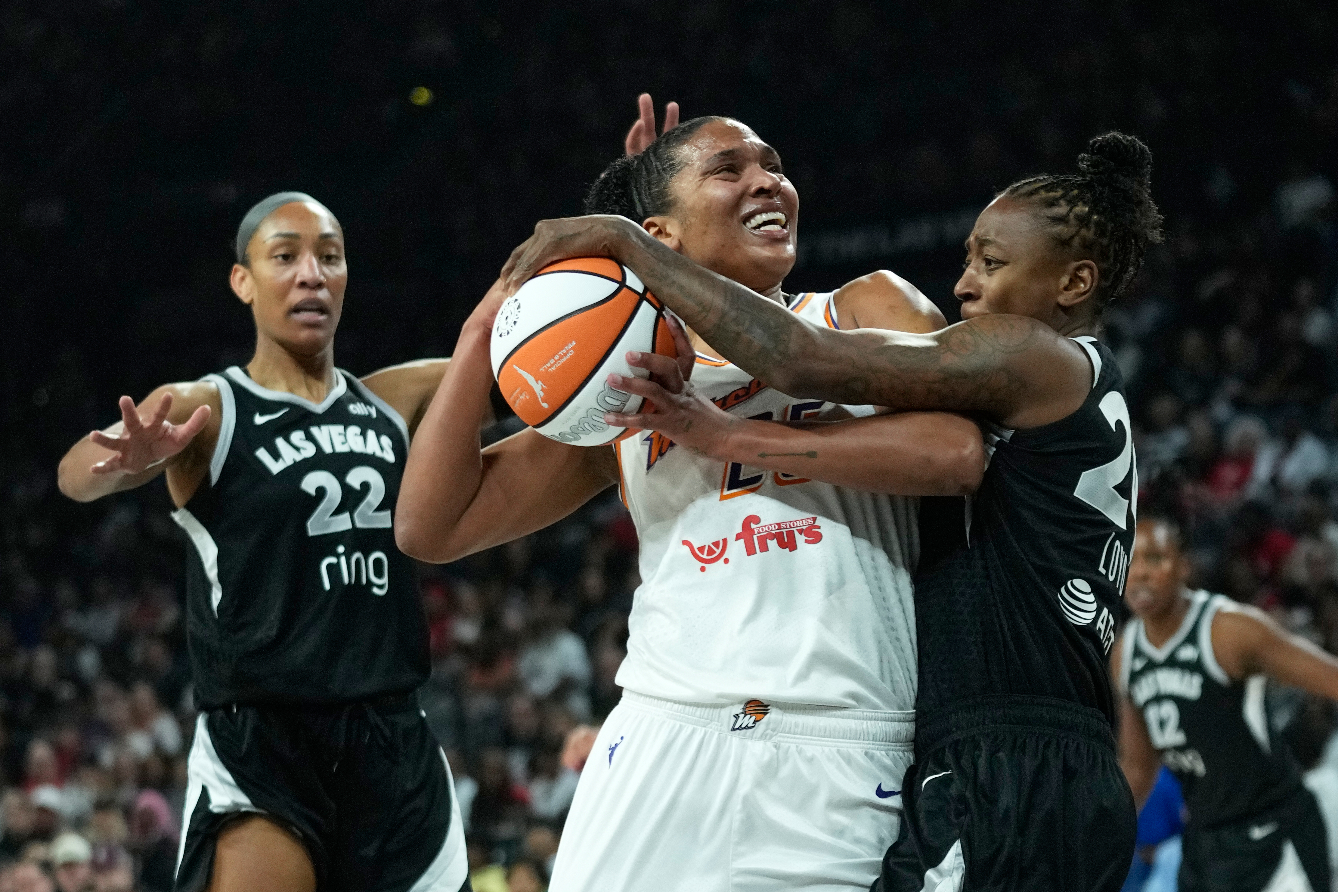 Las Vegas Aces guard Jewell Loyd (24), right, fouls Phoenix Mercury forward Alyssa Thomas (25) during the first half in Game 2 of the WNBA basketball finals, Sunday, Oct. 5, 2025, in Las Vegas.