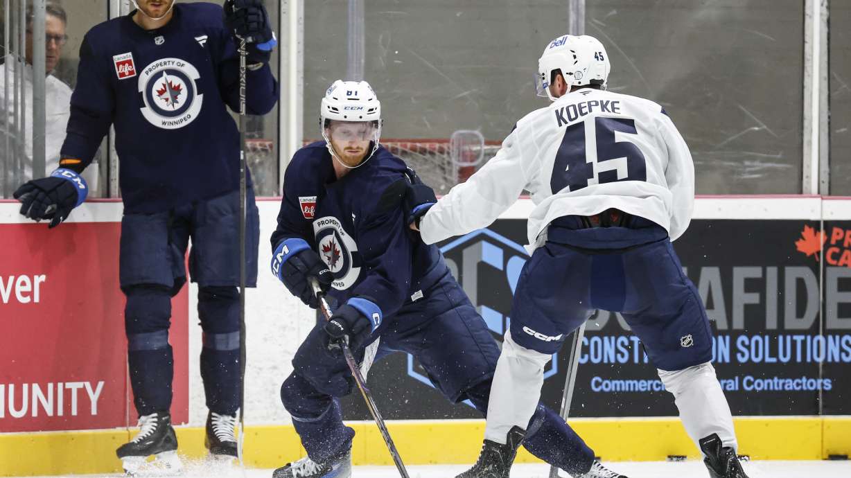 Winnipeg Jets' Gabriel Vilardi (13) looks on as Kyle Connor (81) and Cole Koepke (45) battle in the corner during NHL hockey training camp in Winnipeg, Manitoba, Thursday, Sept. 18, 2025.