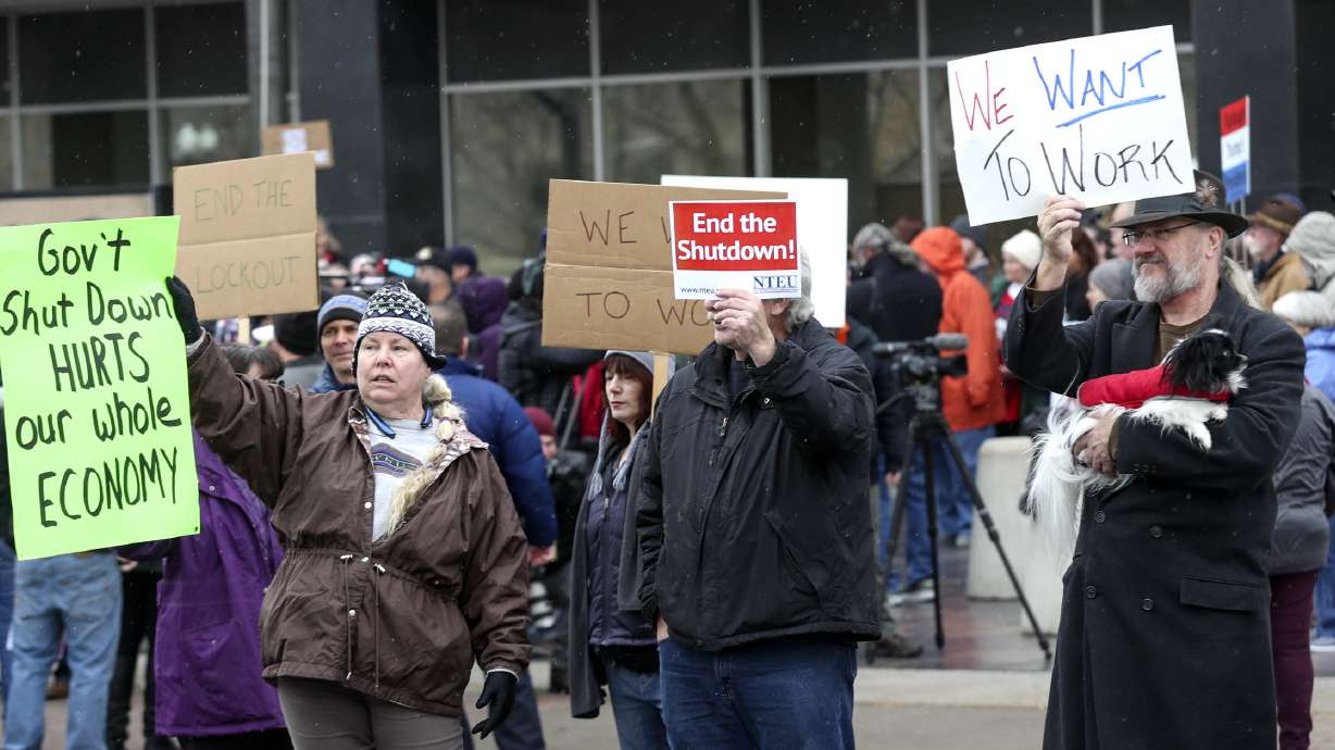 The IRS announced furloughs Wednesday due to the government shutdown. The Jan. 10, 2019, photo shows demonstrators protesting the 35-day shutdown in late 2018 and early 2019 in Ogden.