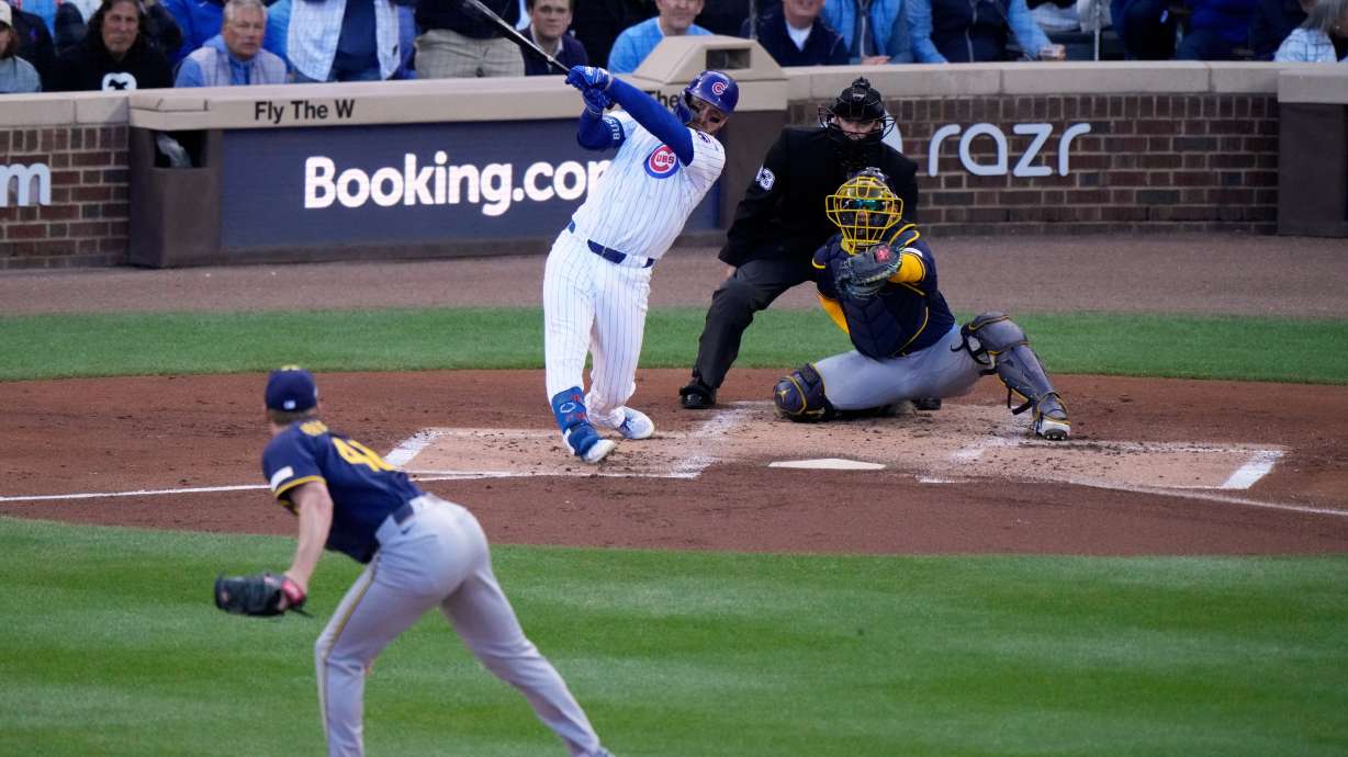 Chicago Cubs' Michael Busch hirts a home run during the first inning of Game 3 of baseball's National League Division Series against the Milwaukee Brewers Wednesday, Oct. 8, 2025, in Chicago.