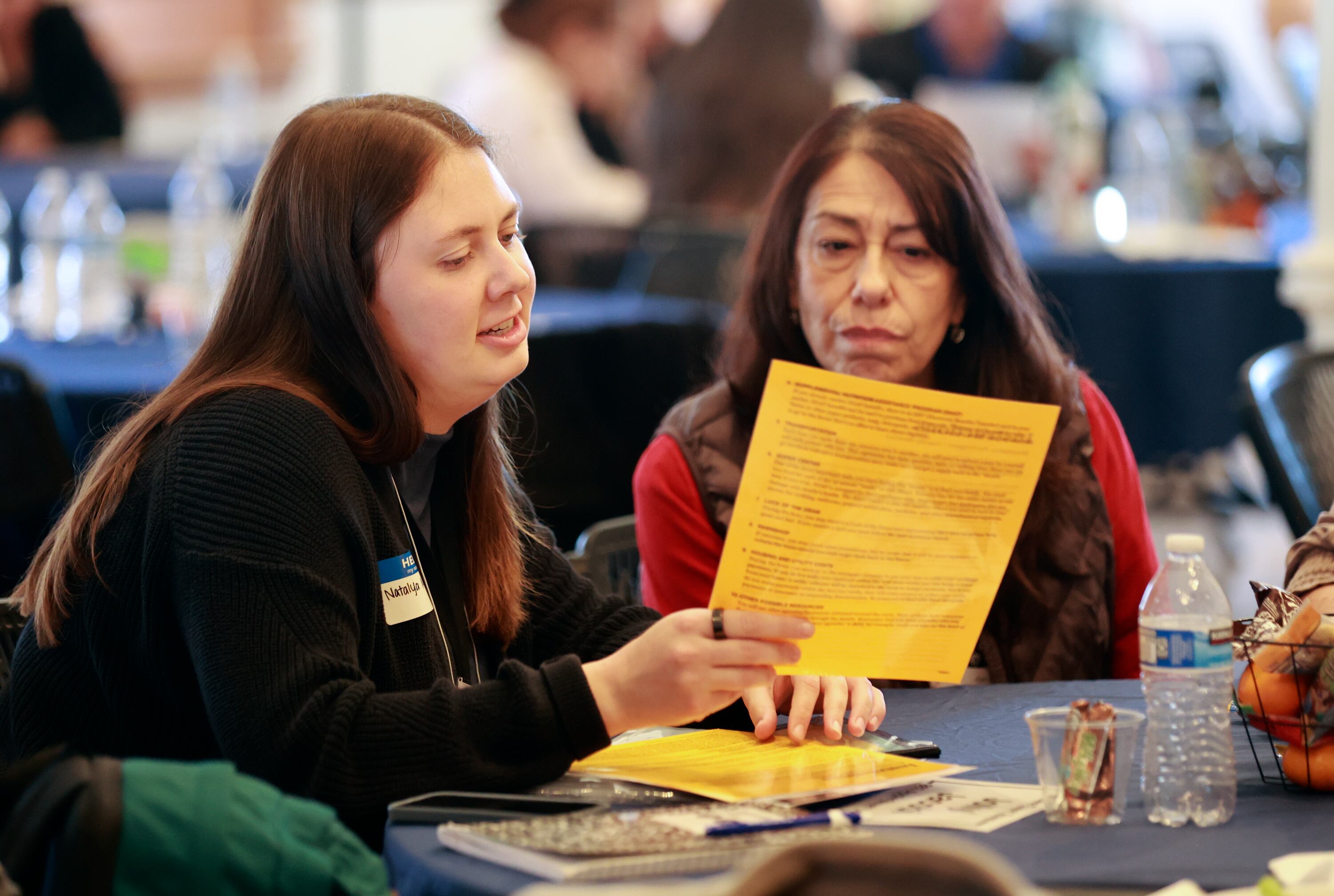 Natalya Millet, United Way Welcome Baby program coordinator, and Sandi Nelson, Orem Junior High School community outreach liaison, participate in a poverty simulation at the kNOw Poverty Summit at Provo City Library at Academy Square in Provo on Wednesday.