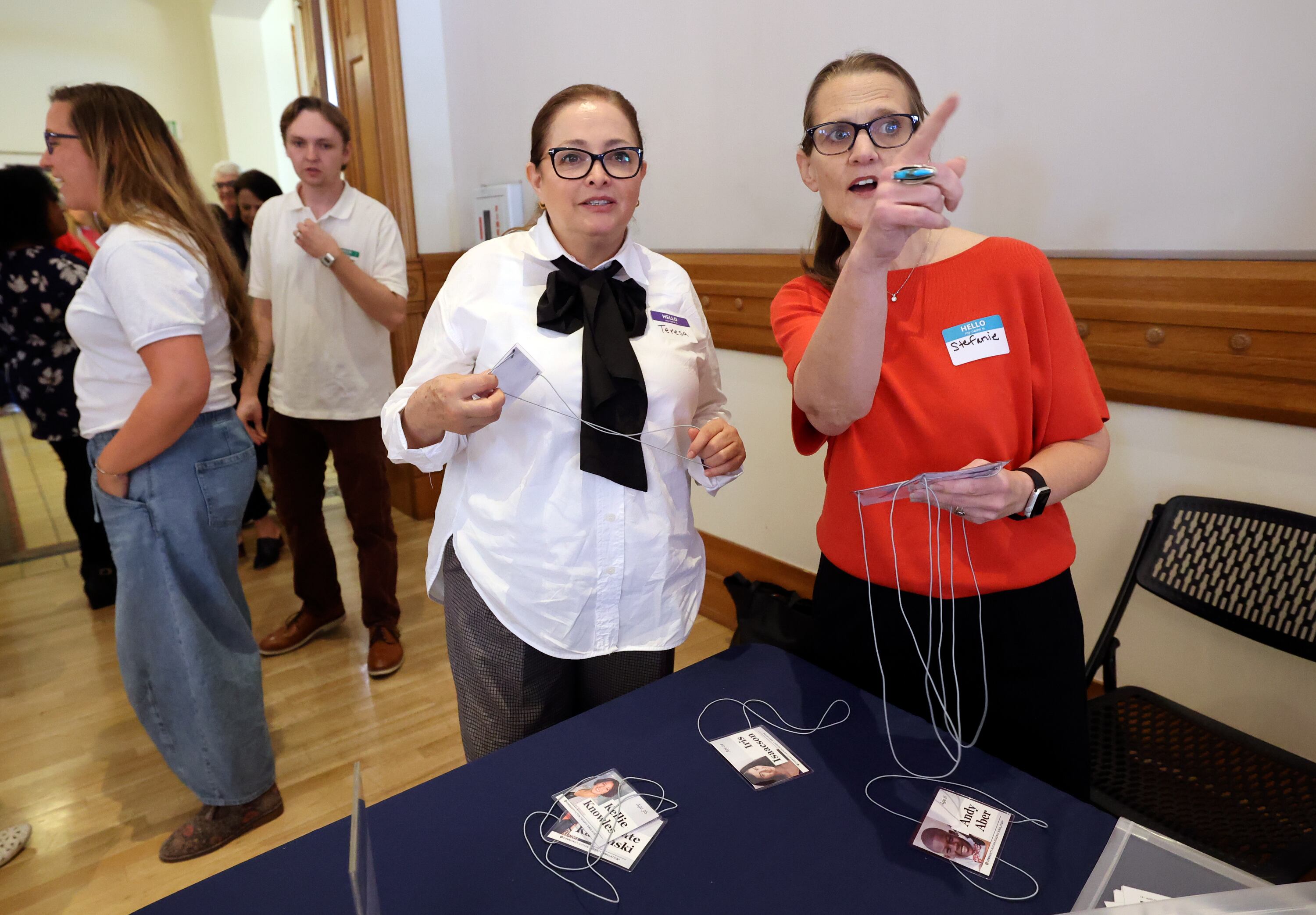 Teresa Guajardo, Lehi family employment counselor, gets assigned a role to play in a poverty simulation by Stefanie Jones, Community Action Partnership of Utah program manager, at the kNOw Poverty Summit at Provo City Library at Academy Square in Provo on Wednesday.