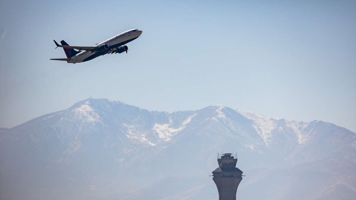 A plane takes off near the airport traffic control tower at Salt Lake City International Airport in Salt Lake City on Wednesday.