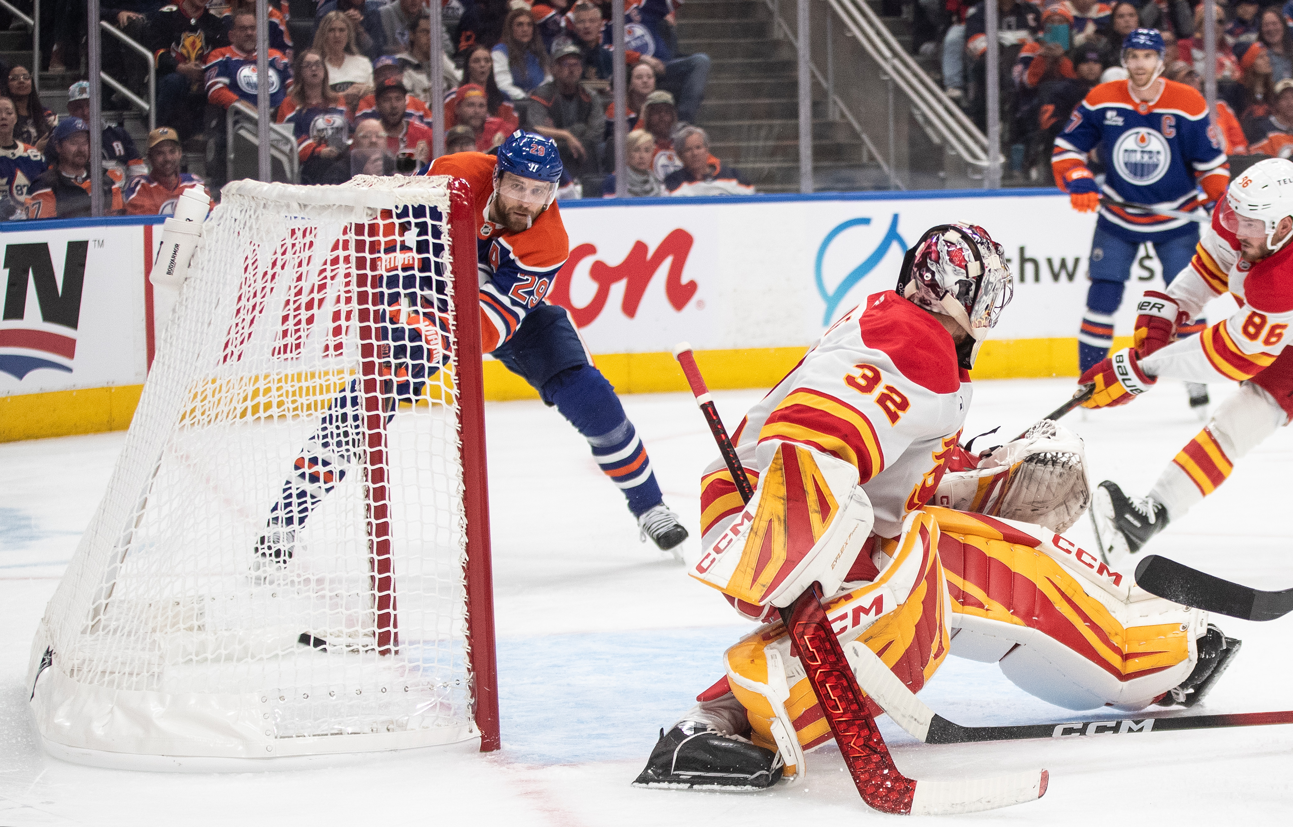 Edmonton Oilers' Leon Draisaitl (29) scores his 400th career goal against Calgary Flames goalie Dustin Wolf (32) during second period NHL action, in Edmonton on Wednesday, Oct. 8, 2025.