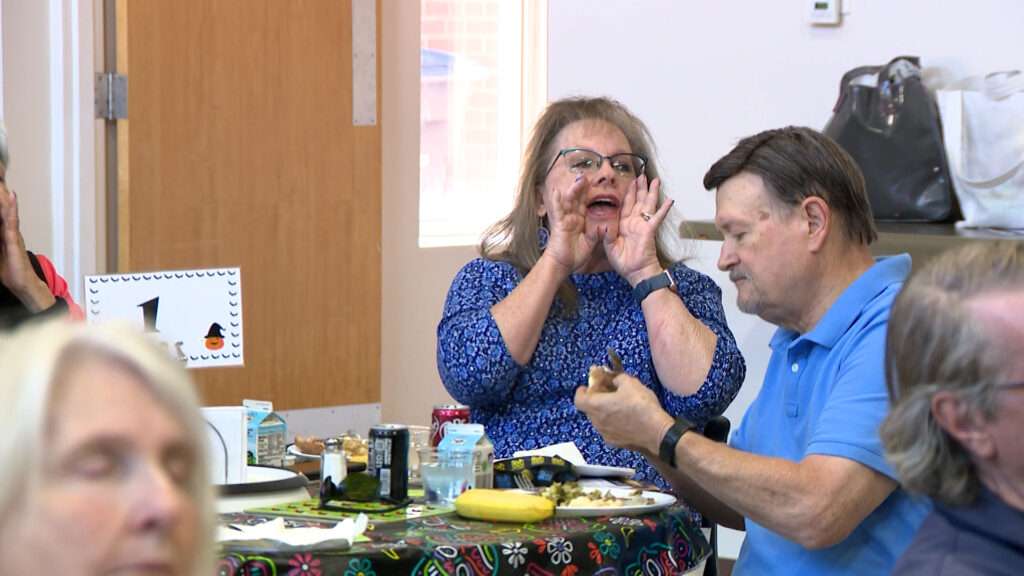 Linda Allredge cheers at the announcement of a new senior center in South Jordan, Wednesday.