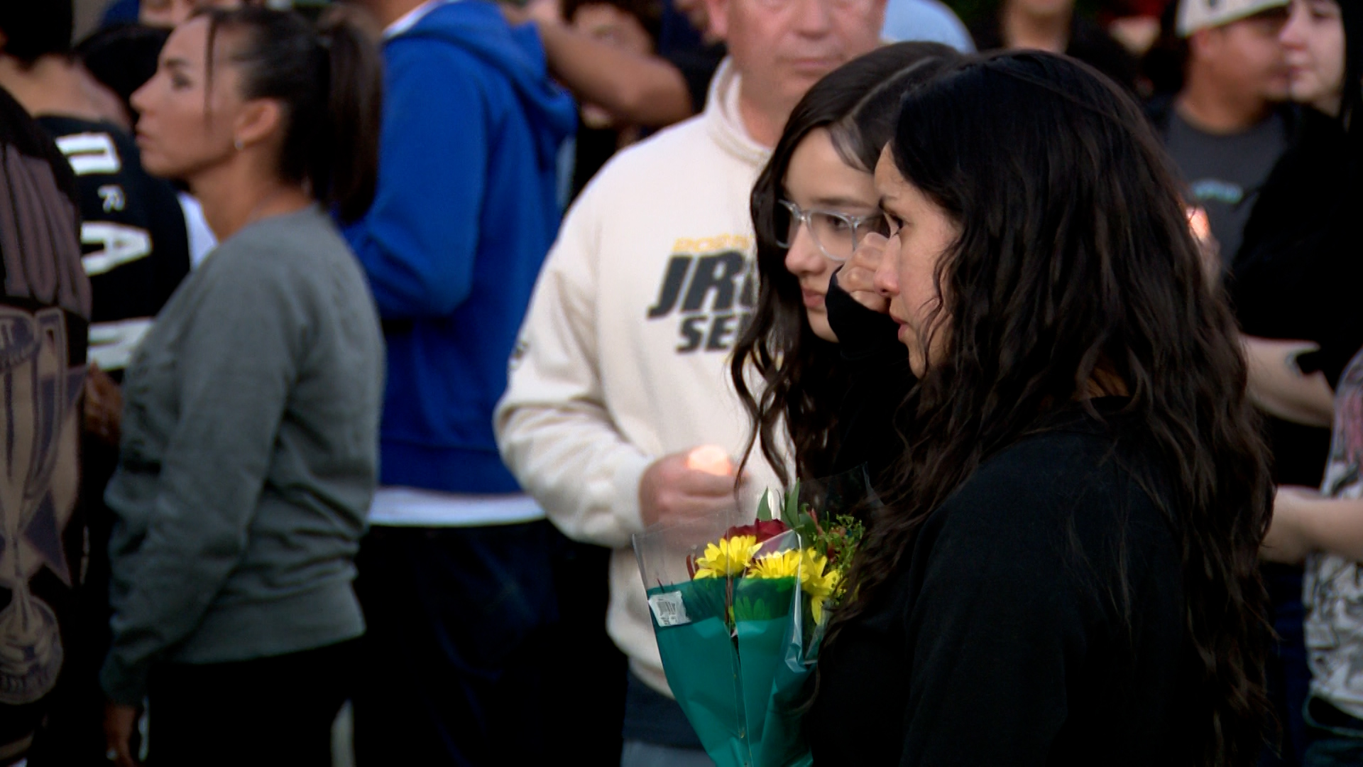 A woman wipes her eyes at a vigil held in Ogden on Wednesday to honor 16-year-old Mason Caballero, who was shot and killed near Ben Lomond High School on Tuesday.
