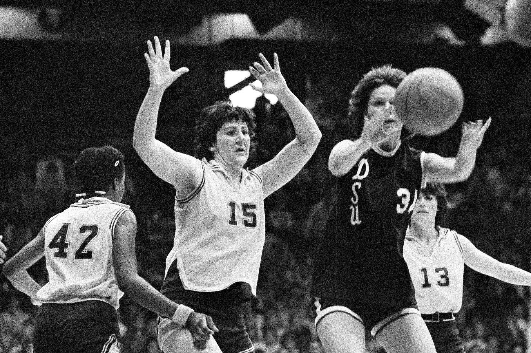 FILE - Louisiana State's Maree Bennie (15) throws up her arms in defense as Delta State's Wanda Hairston of Delta State passes the ball during the finals of the AIAW national basketball championships in Minneapolis, Minn., March 28, 1977.
