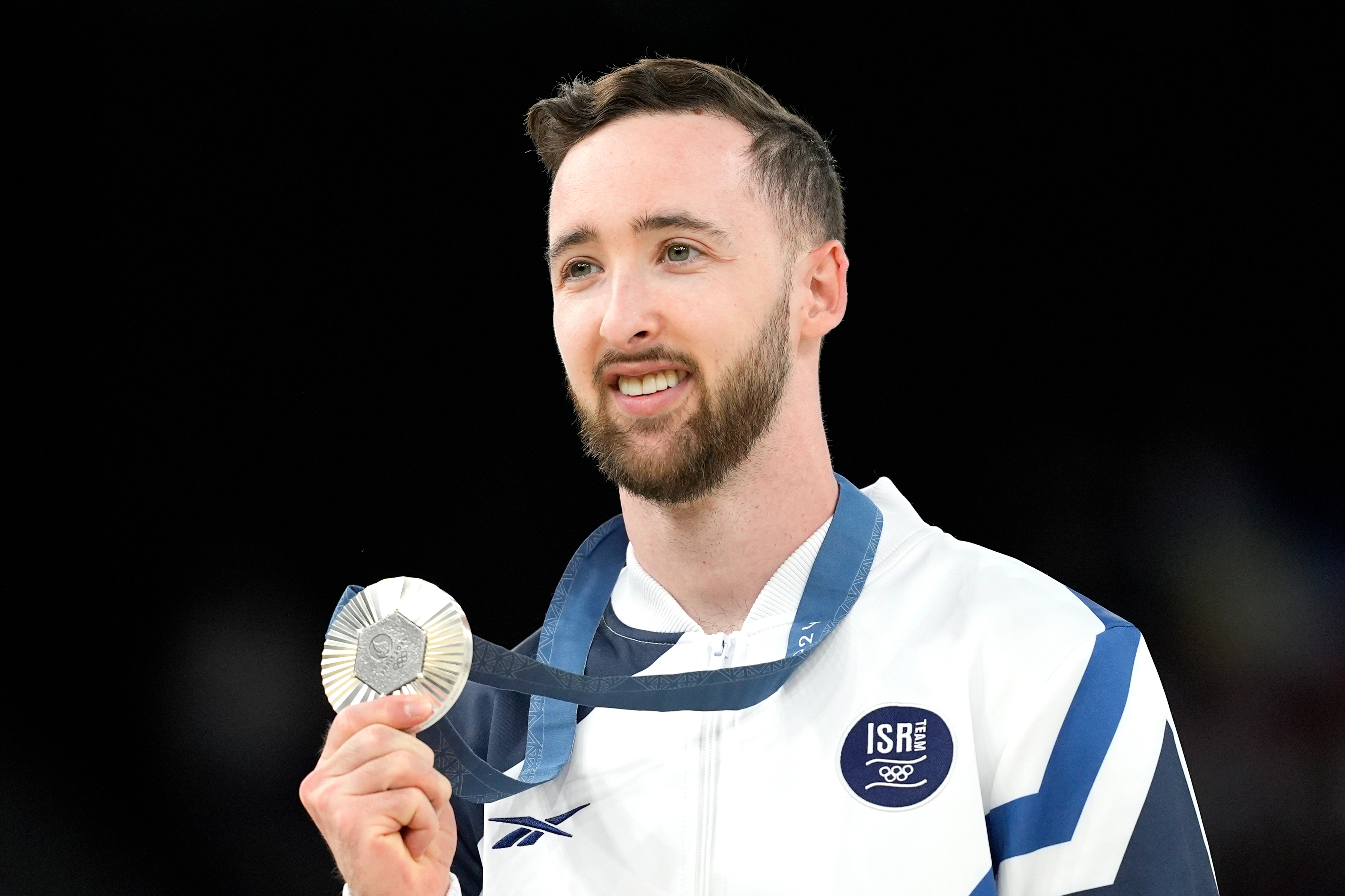 FILE - Artem Dolgopyat of Israel celebrates after winning the silver medal during the men's artistic gymnastics individual floor finals at Bercy Arena at the 2024 Summer Olympics, Saturday, Aug. 3, 2024, in Paris, France.