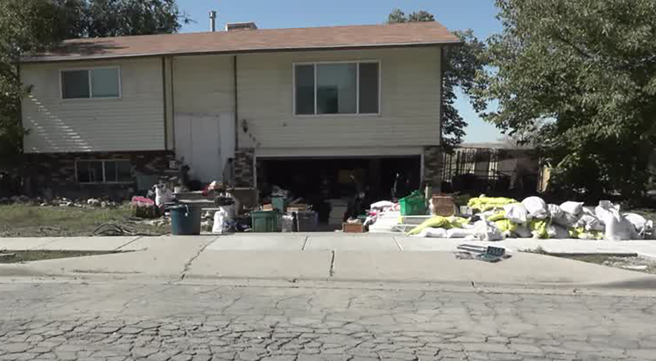 Damaged belongings are seen outside a home in Westpointe neighborhood of Salt Lake City on Wednesday after a weekend flood.