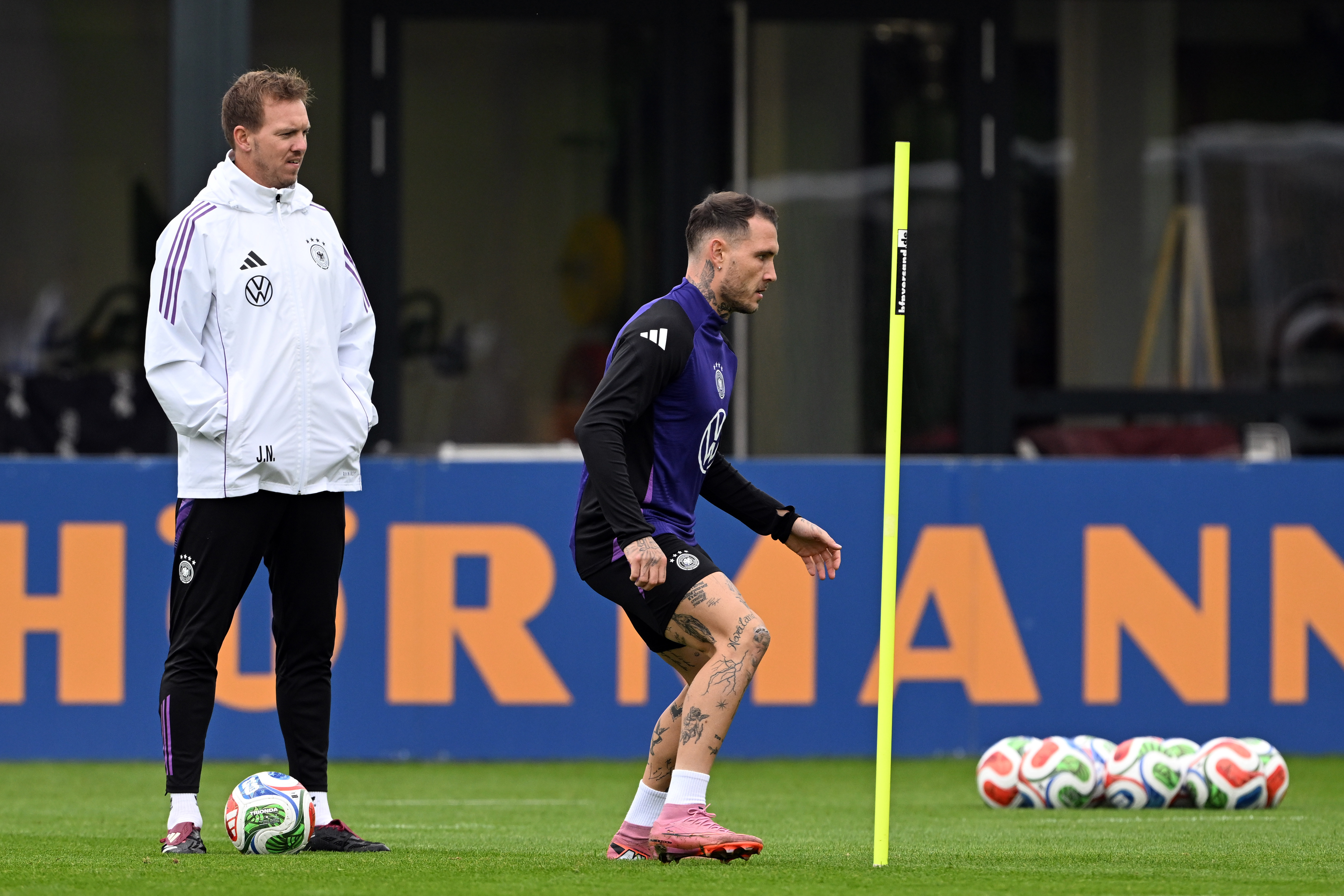 Germany's head coach Julian Nagelsmann, left, and player david Raum attend a training session of the German national soccer team in Herzogenaurach, Germany, Tuesday, Oct. 7, 2025, ahead of the World Cup qualifier soccer match against Luxembourg.