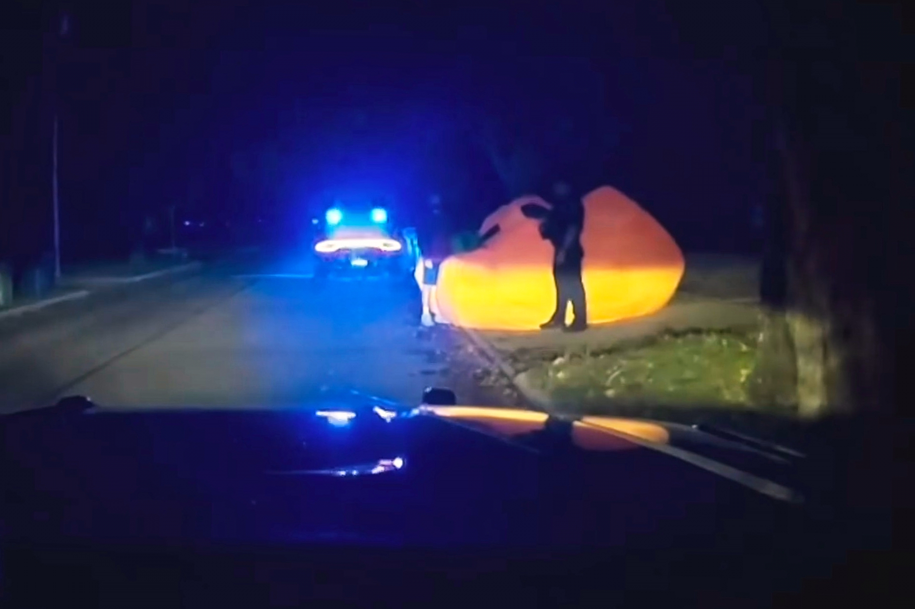 A police officer approaching a runaway inflatable pumpkin on Tuesday. The officers had some trouble wrangling the inflatable object, but were able to prevent it from causing havoc on the roads.