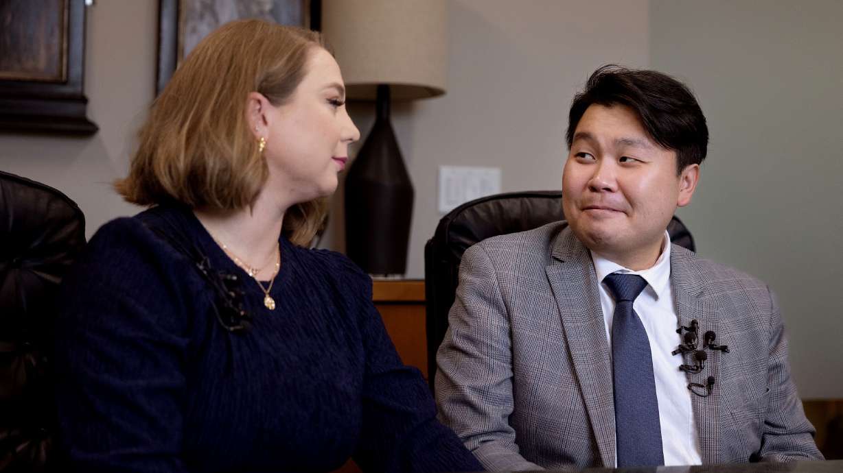 Immigration officials are no longer seeking deportation of Utah violinist John Shin, right. He's pictured with wife DaNae Snow on Sept. 5 at the South Salt Lake office of his attorney, Adam Crayk.