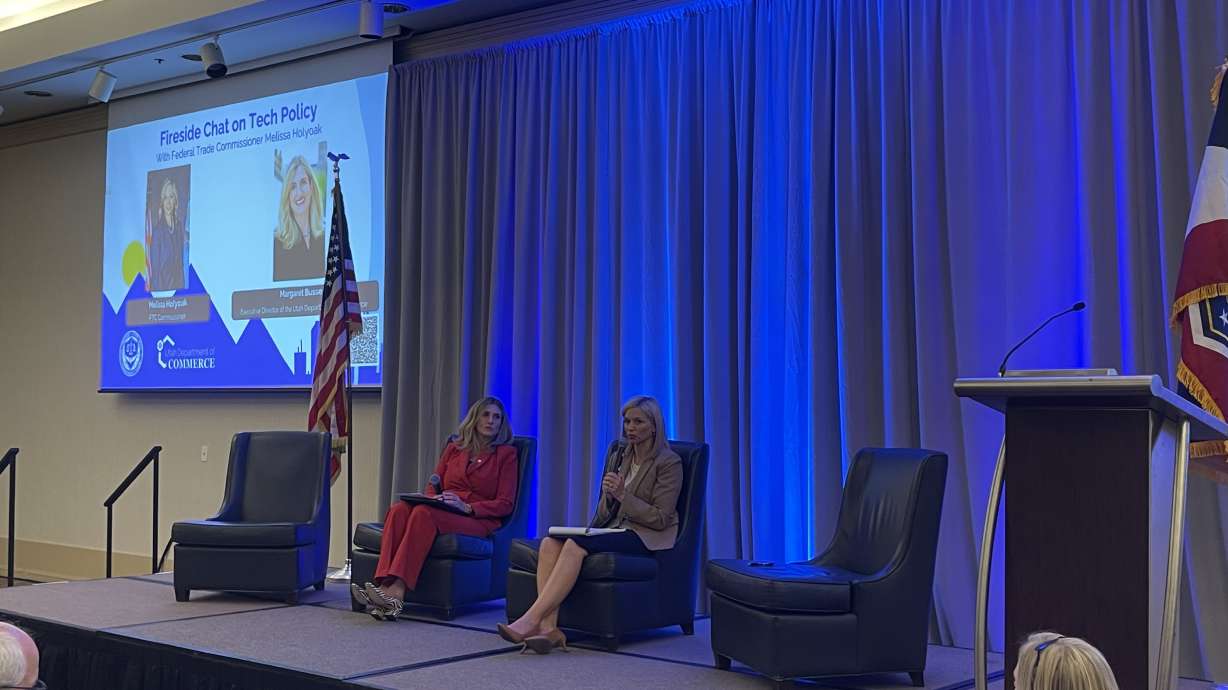 Margaret Busse, executive director at the Utah Department of Commerce, left, talks with Melissa Holyoak, commissioner of the Federal Trade Commission, during the Utah Consumer Protection Symposium in Salt Lake City on Thursday.