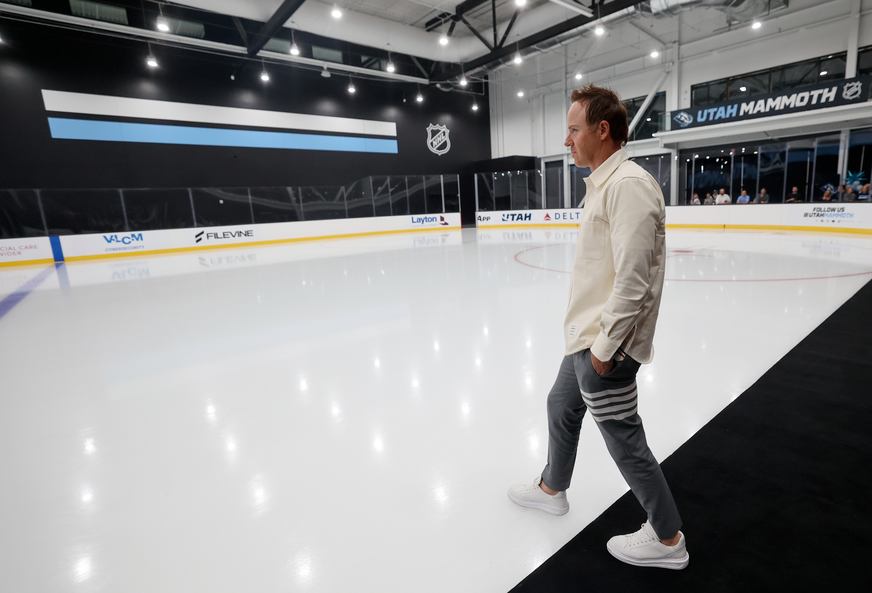 Ryan Smith, owner of the Utah Jazz and Utah Mammoth, steps onto the ice during the unveiling of the Utah Mammoth training facility in Sandy on Sept. 17.