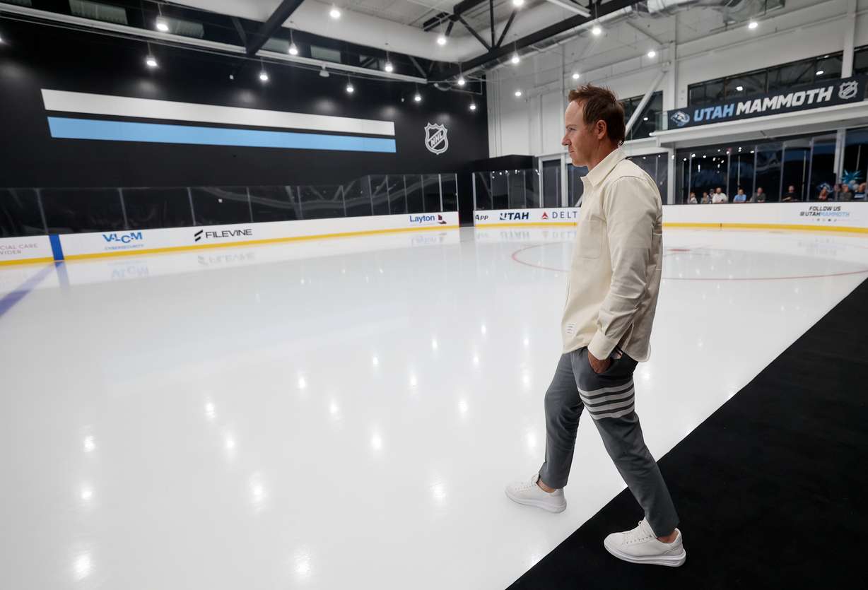 Ryan Smith, owner of the Utah Jazz and Utah Mammoth, steps onto the ice during the unveiling of the Utah Mammoth training facility in Sandy on Sept. 17.