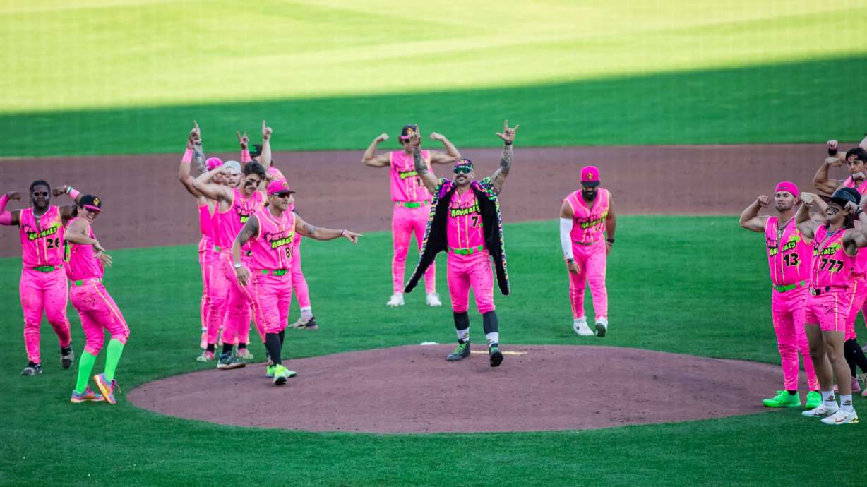 Members of the Party Animals, of the Banana Ball league, dance as they take the field at Smith's Ballpark in Salt Lake City on Aug. 31, 2024. The team will return to Utah for three games at The Ballpark at America First Square next year.