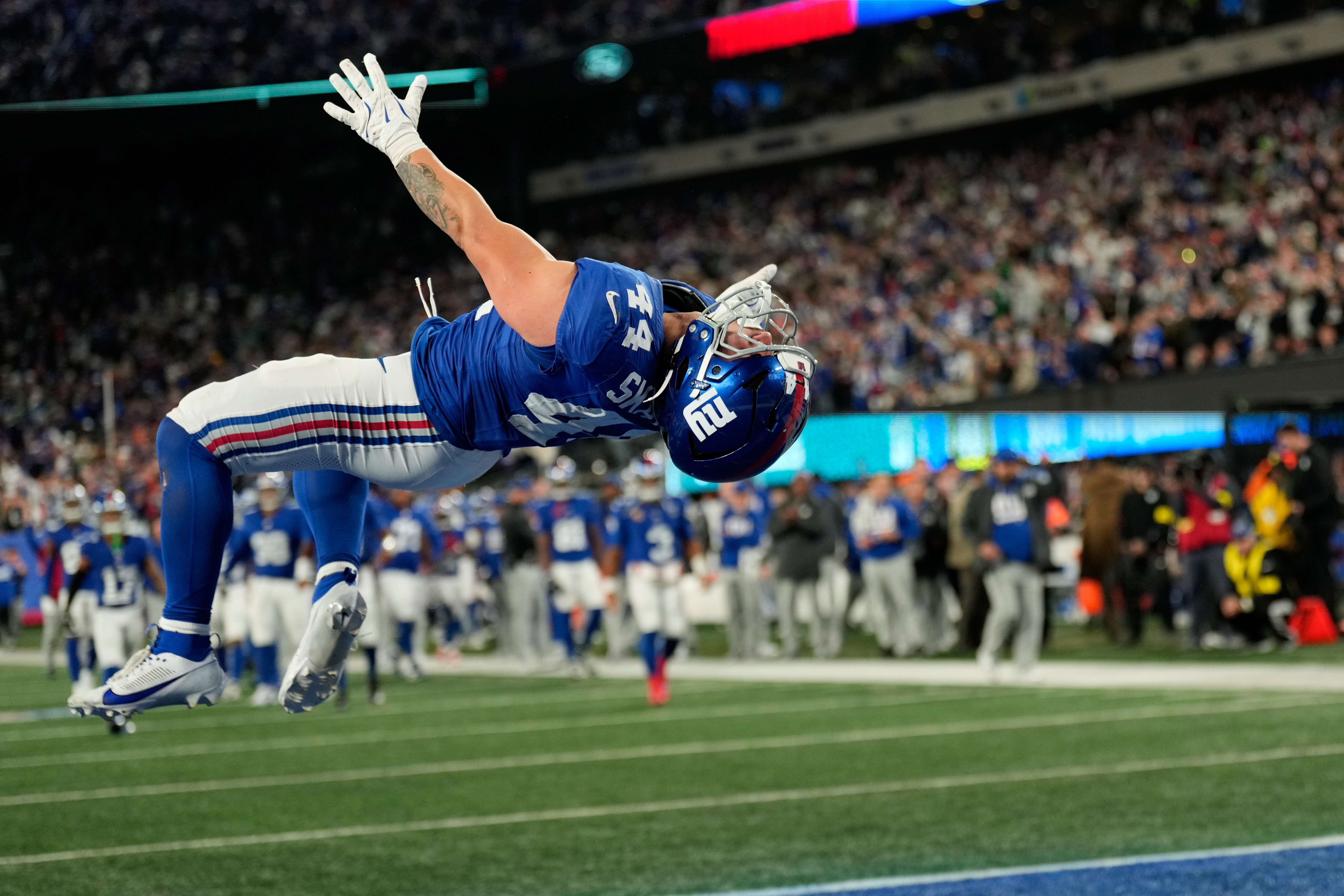 New York Giants' Cam Skattebo reacts after a touchdown during the second half of an NFL football game against the Philadelphia Eagles Thursday, Oct. 9, 2025, in East Rutherford, N.J. 