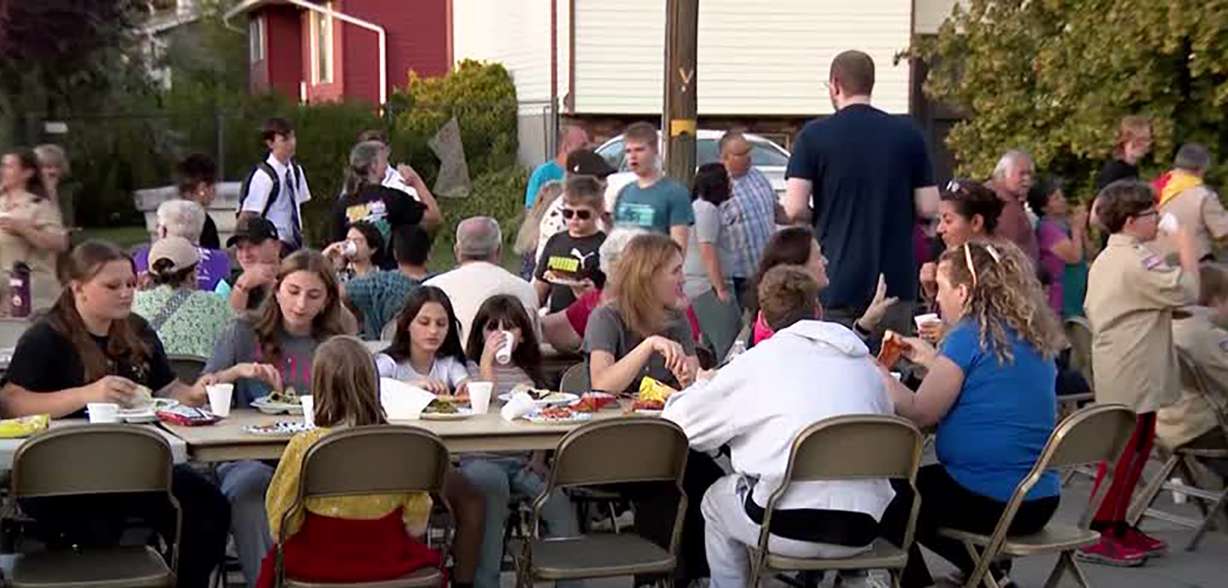 People attend a block party in a Salt Lake neighborhood that experienced damaging floods last weekend, on Thursday.