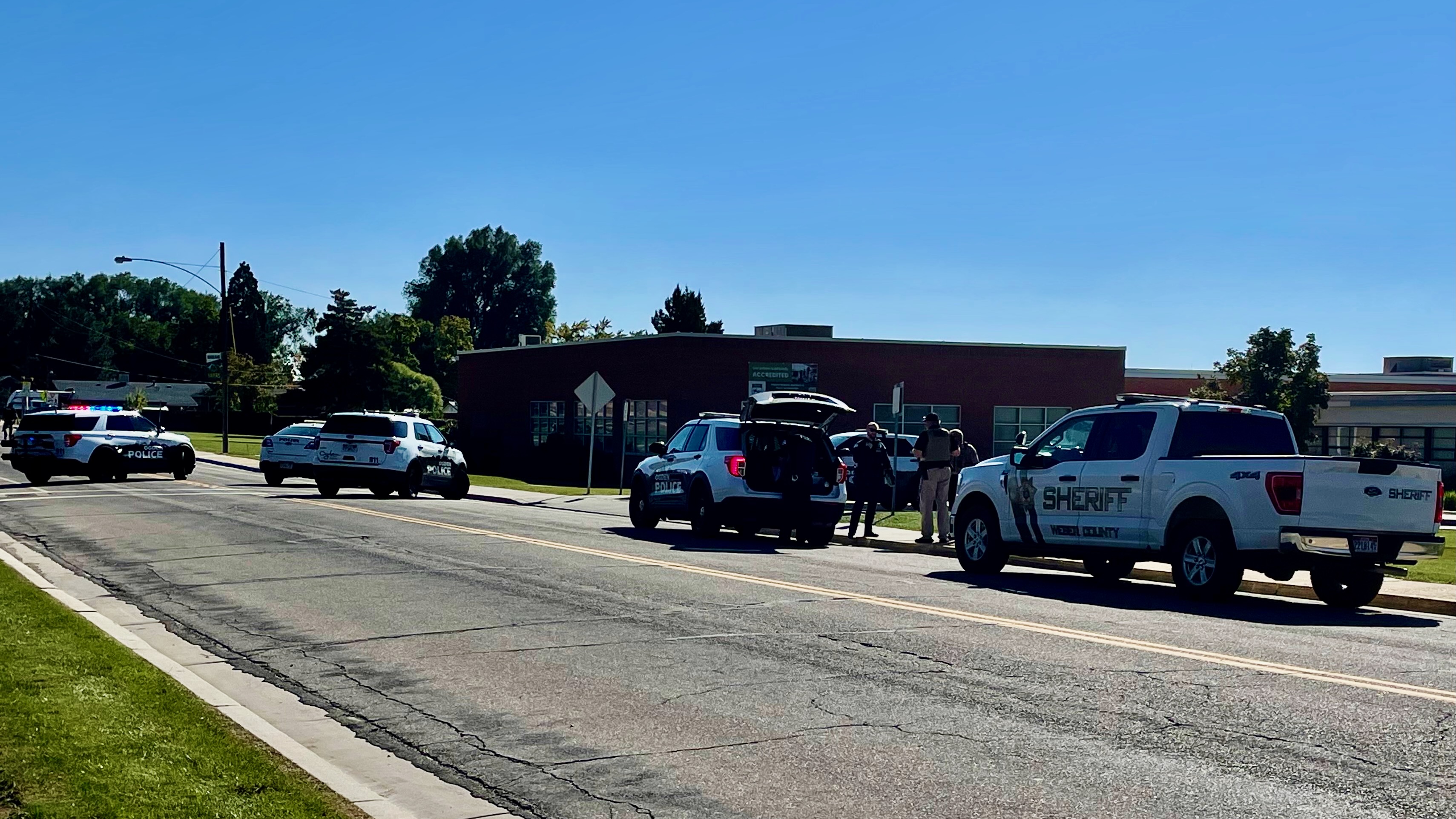 Law enforcement authorities gather along Gramercy Avenue in front of Highland Junior High in Ogden on Tuesday after the fatal shooting of a Ben Lomond High School student in the area.
