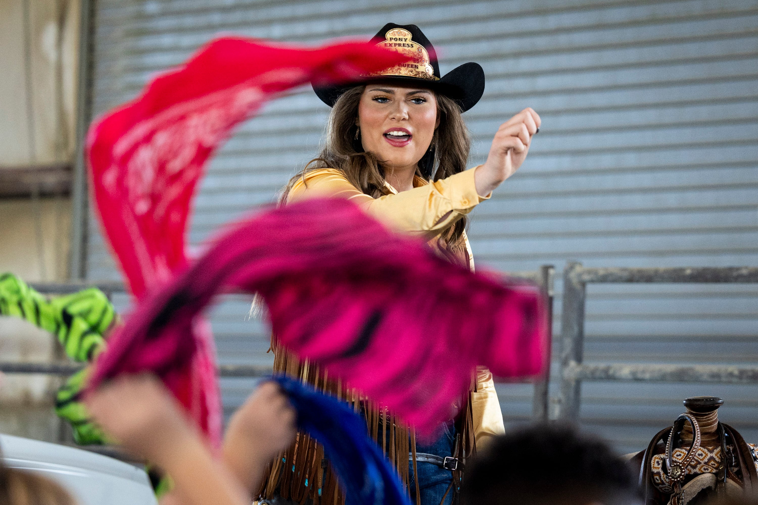 Jane Tanner, the Pony Express Rodeo Queen, talks with second graders as they wave handkerchiefs during Utah County Farm Field Days held by the Utah Farm Bureau and Utah State University Extension at the North Utah County Equestrian Park in Highland on Thursday.