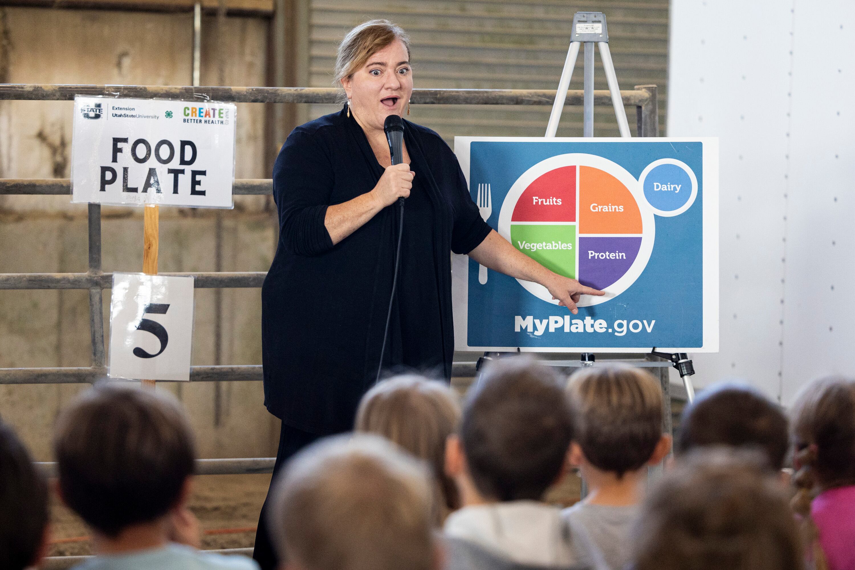 Michelle Shrader, with the Utah State University Extension Master Gardener Program, talks about different kinds of foods to second graders during Utah County Farm Field Days held by the Utah Farm Bureau and Utah State University Extension at the North Utah County Equestrian Park in Highland on Thursday.