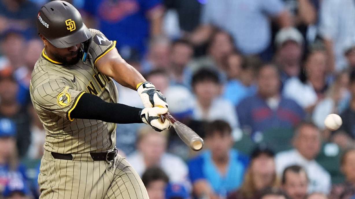 San Diego Padres' Xander Bogaerts hits a single during the seventh inning of Game 3 of a National League wild card baseball game against the Chicago Cubs Thursday, Oct. 2, 2025, in Chicago.