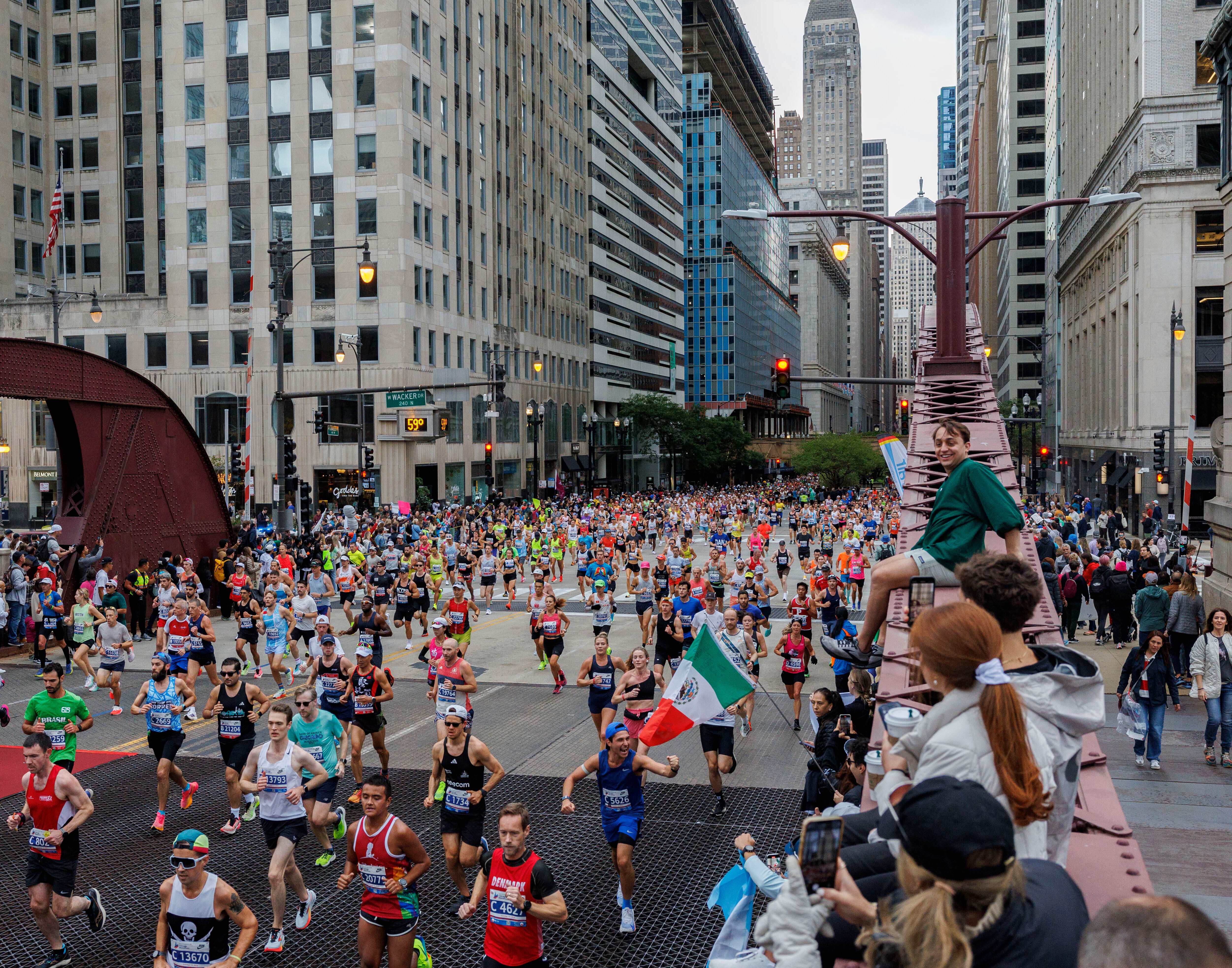 FILE - Runners cross the LaSalle Street bridge during the Chicago Marathon, Sunday, Oct. 13, 2024, in Chicago.
