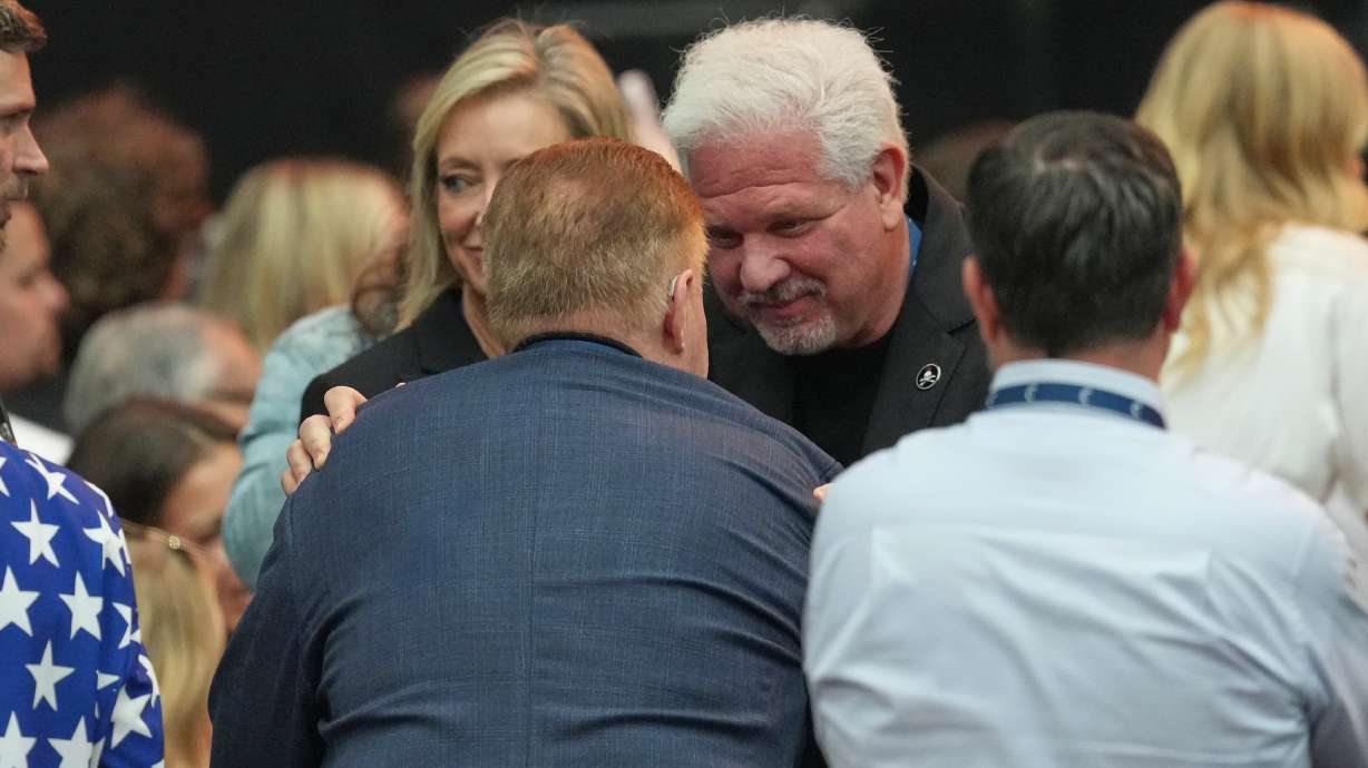 Glenn Beck is greeted by a supporter at a memorial service for Charlie Kirk, Sept. 21, at State Farm Stadium in Glendale, Ariz. Beck told an audience at the University of North Dakota on Thursday he hoped to have Kirk succeed him.