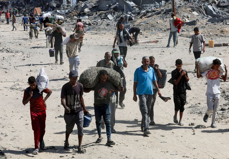Palestinians return to Khan Younis, in the southern Gaza Strip, Friday. The area was the hardest hit by Israeli offensives.
