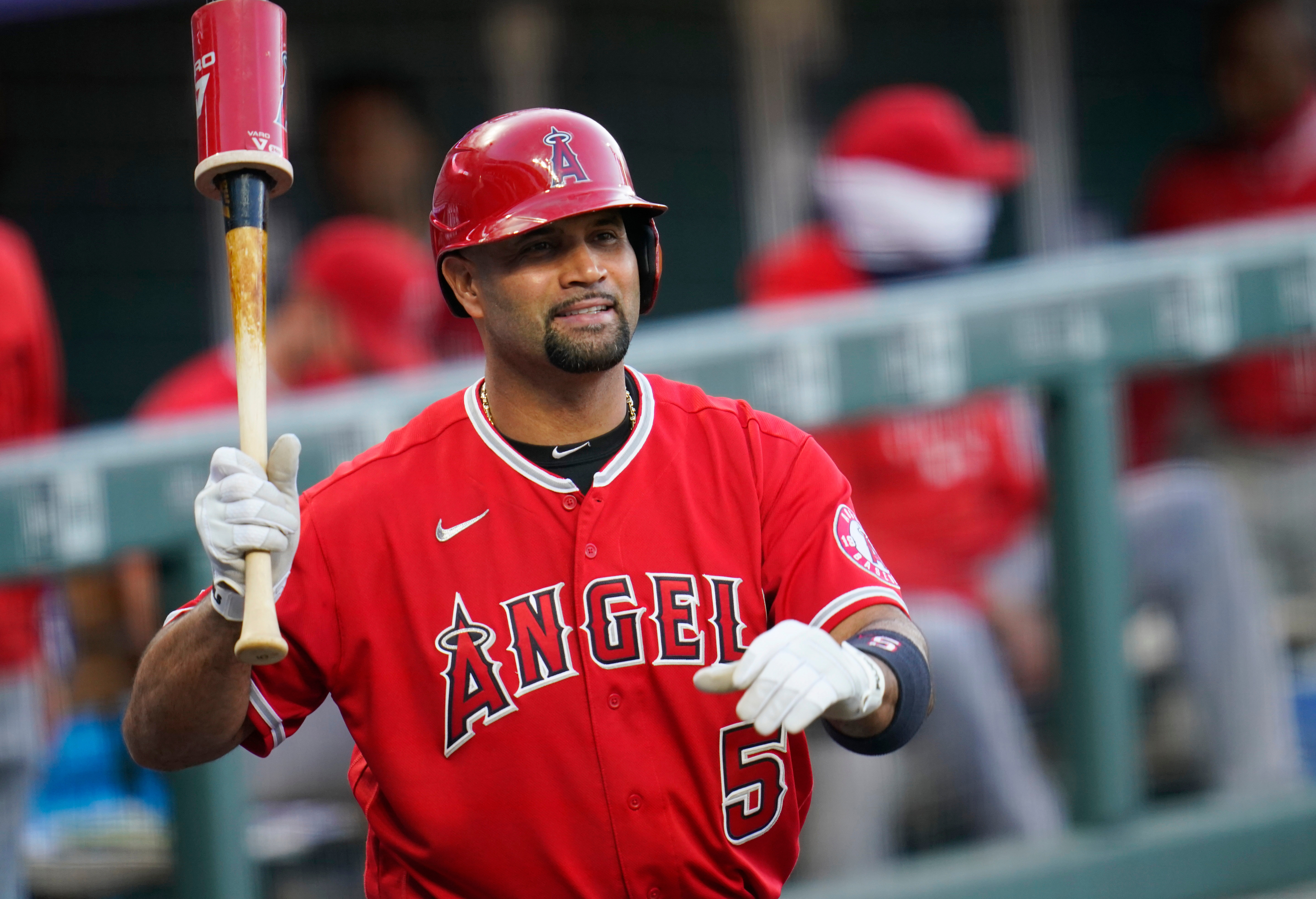 FILE - Los Angeles Angels designated hitter Albert Pujols waves to players in the Colorado Rockies dugout in the second inning of a baseball game, Sept. 12, 2020, in Denver.
