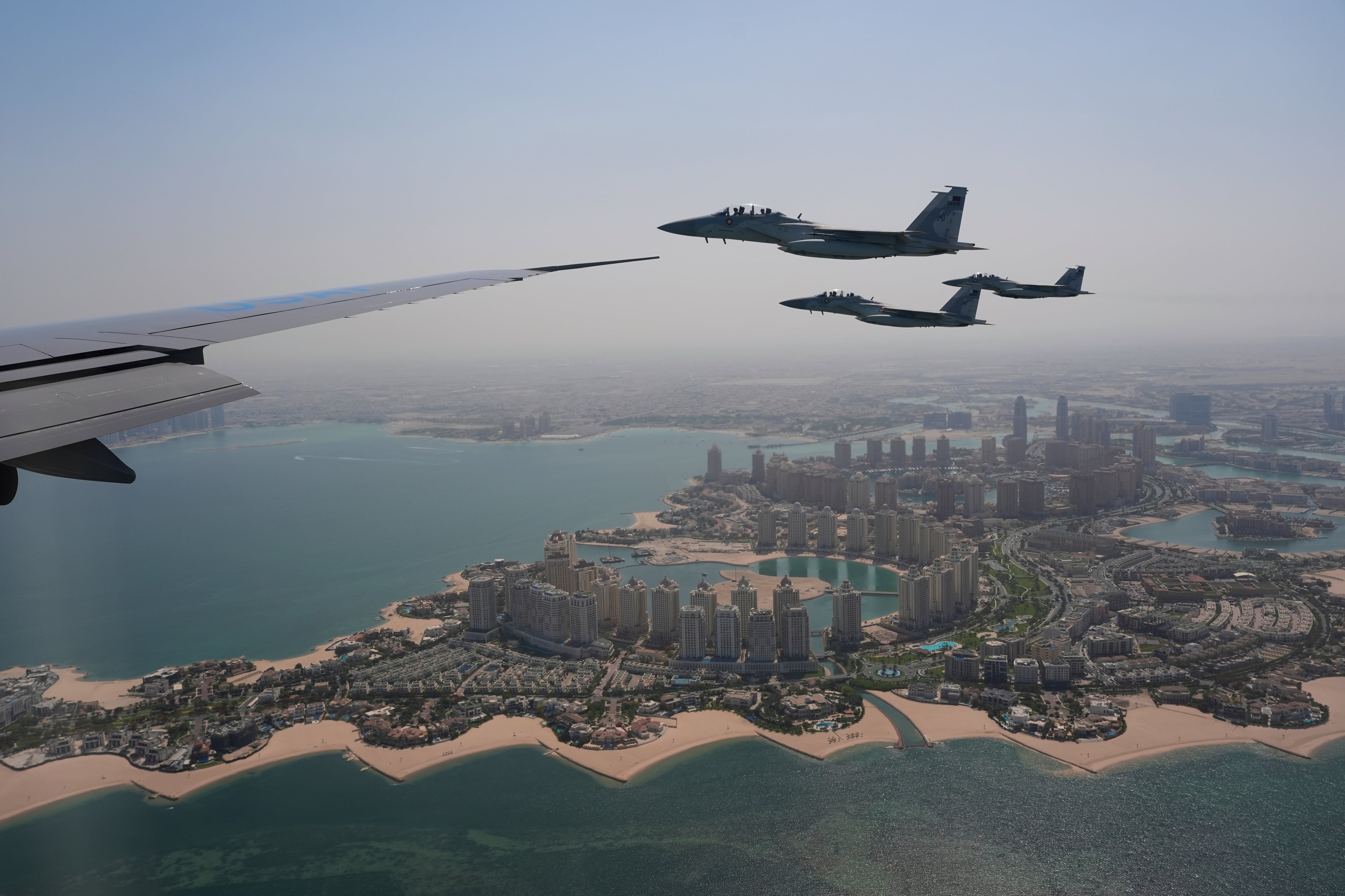 Qatar Emiri Air Force F-15s provide an honorary escort for Air Force One, carrying President Donald Trump, as it arrives in Doha, Qatar, May 14.