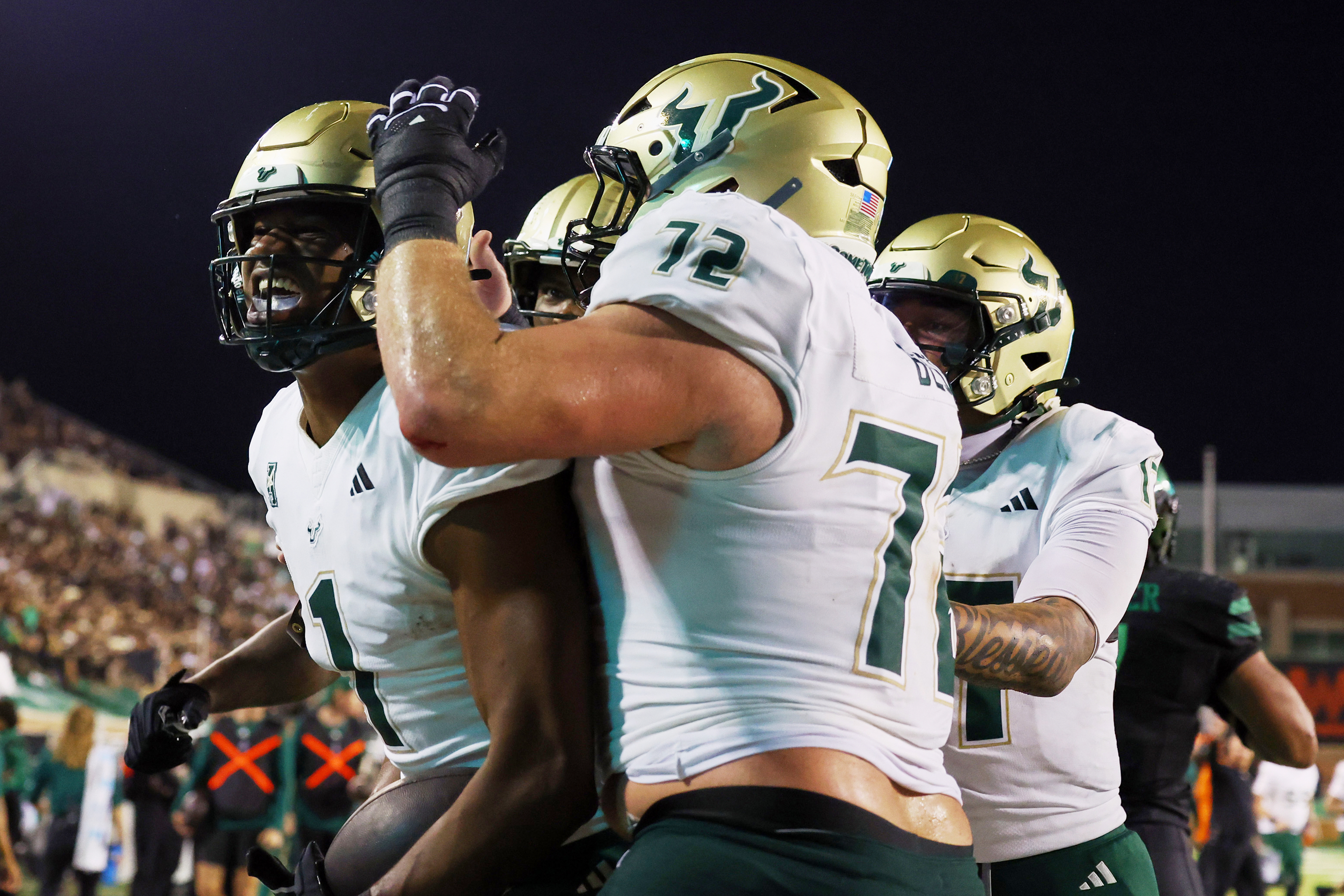 South Florida tight end Johnathan Echols celebrates a touchdown with Cole Best (72) and quarterback Byrum Brown (17) against North Texas in an NCAA college football game Friday, Oct. 10, 2025, in Denton, Texas. 