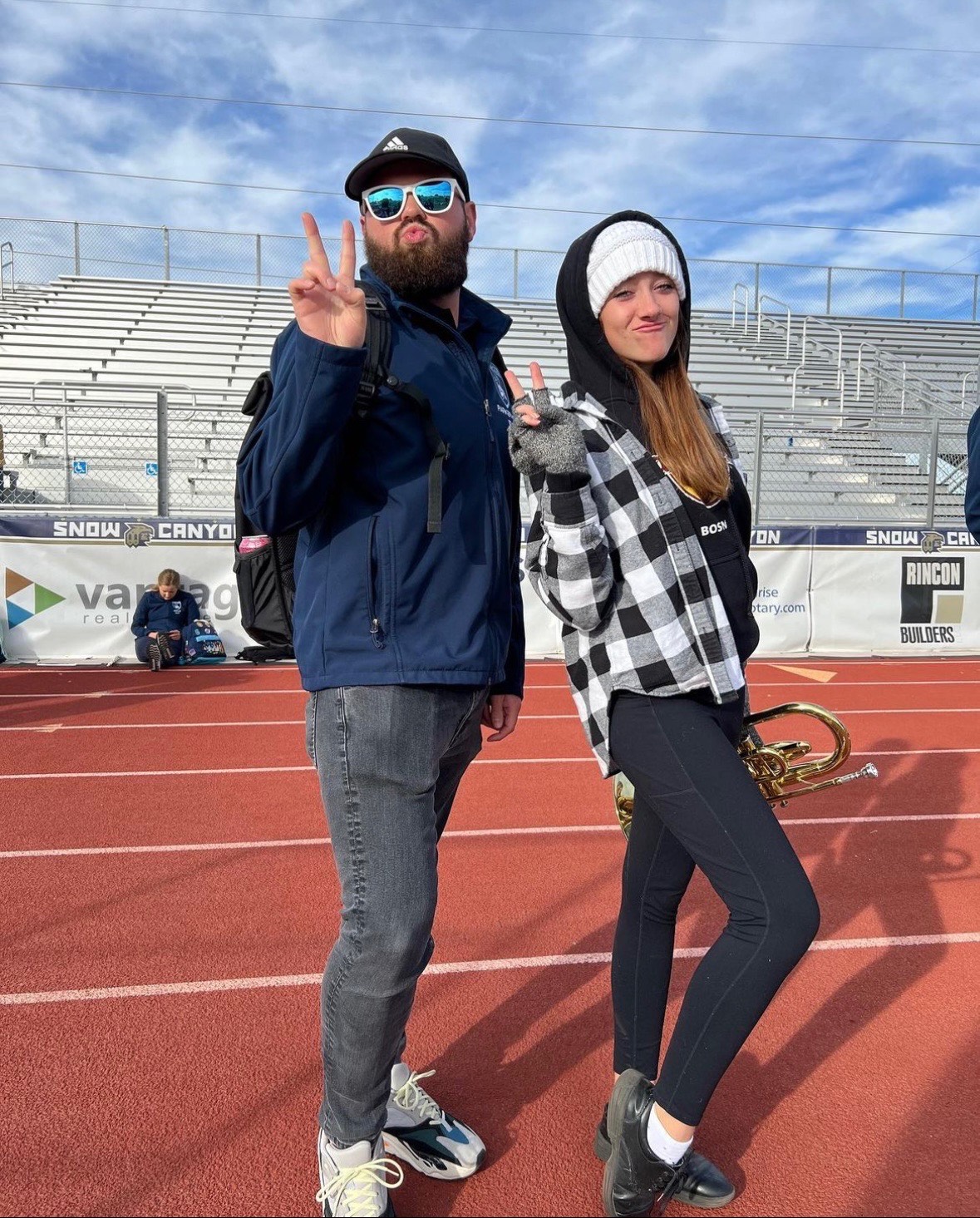 Parker Holt and former student Halle Arnold after a Westlake High School marching band practice. Holt, who directs the band, is facing his second brain cancer diagnosis.