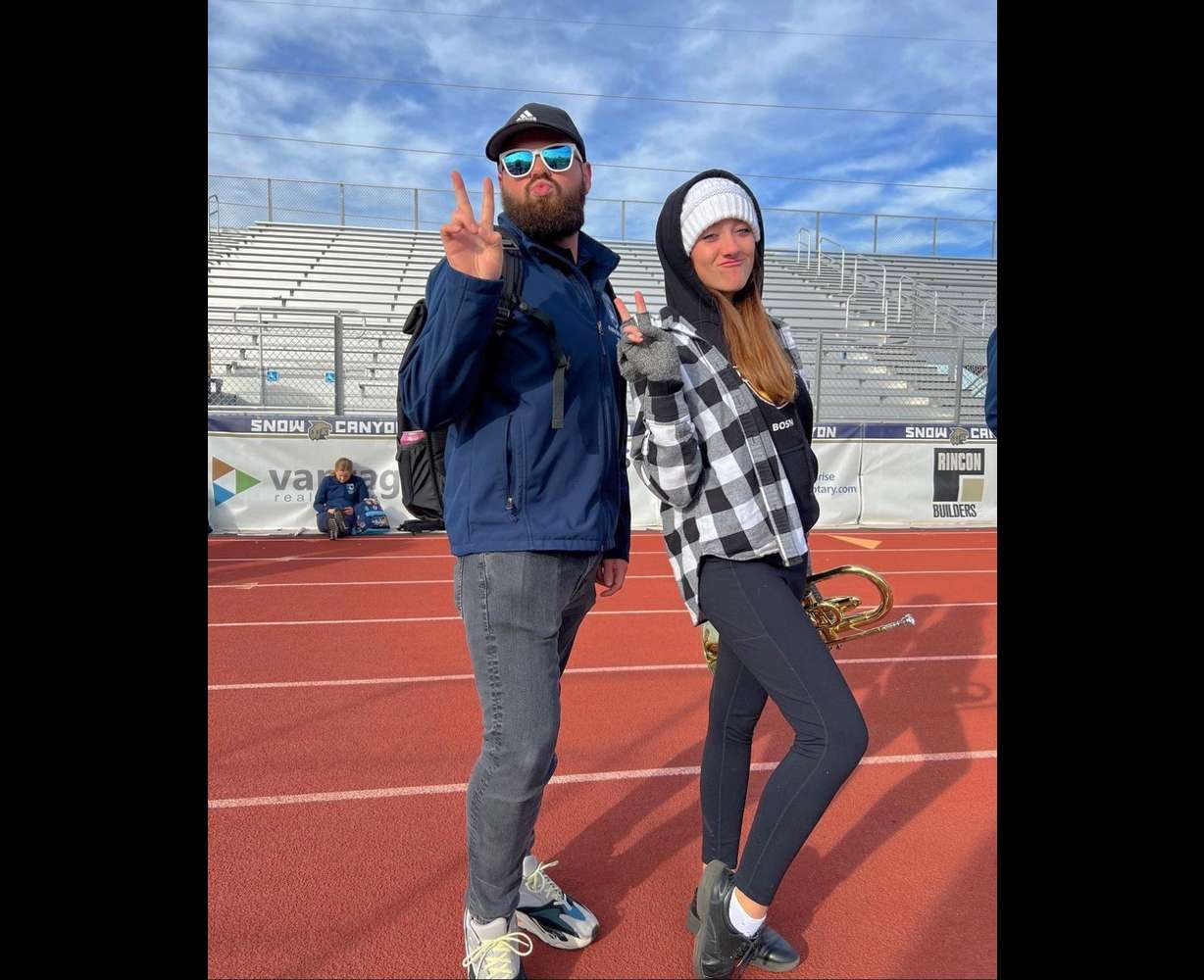 Parker Holt and former student Halle Arnold after a Westlake High School marching band practice. Holt, who directs the band, is facing his second brain cancer diagnosis.