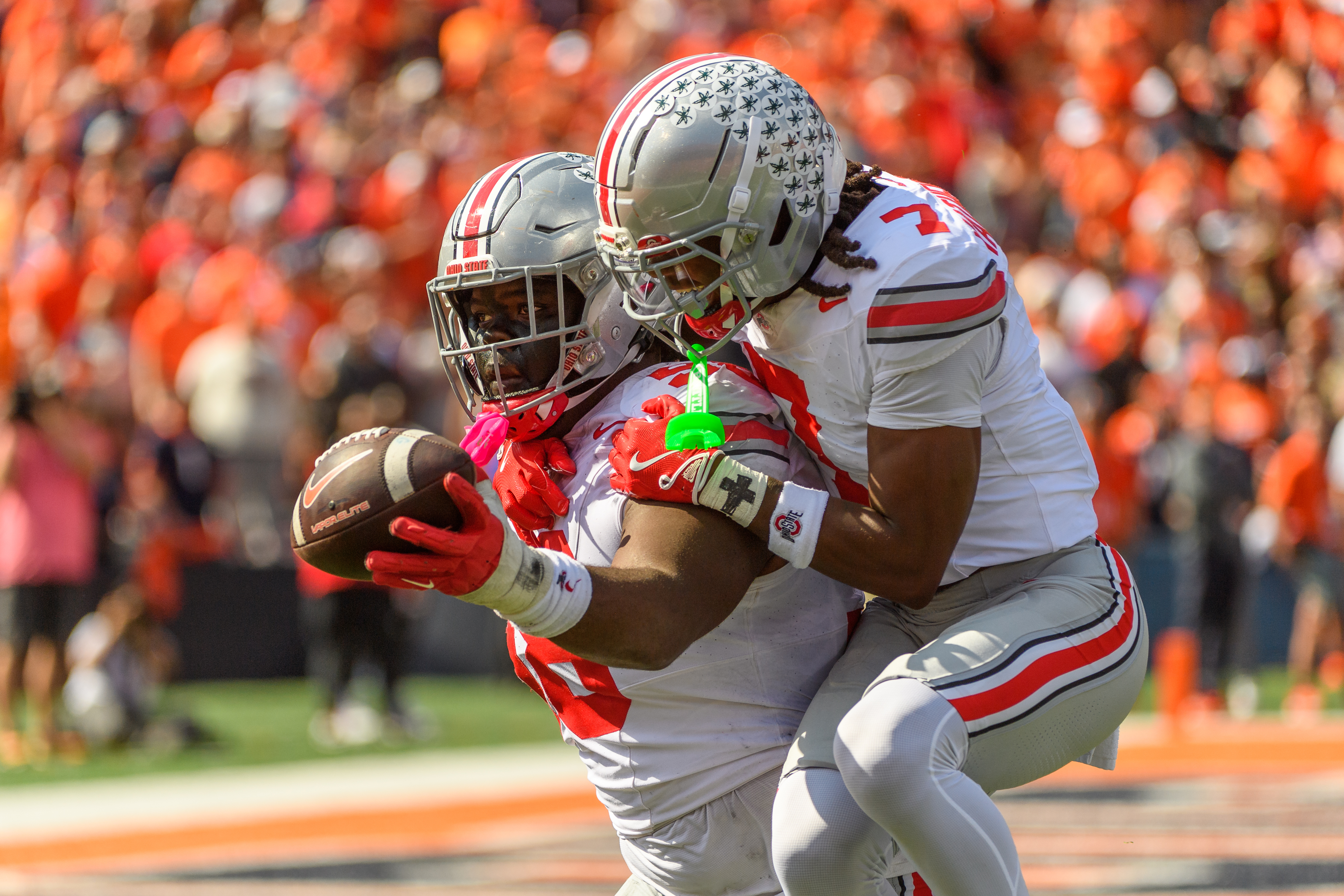 Ohio State defensive lineman Kayden McDonald (98) and cornerback Jermaine Mathews Jr. (7) celebrate a fumble recovery during the first half of an NCAA college football game against Illinois, Saturday, Oct. 11, 2025, in Champaign, Ill. 