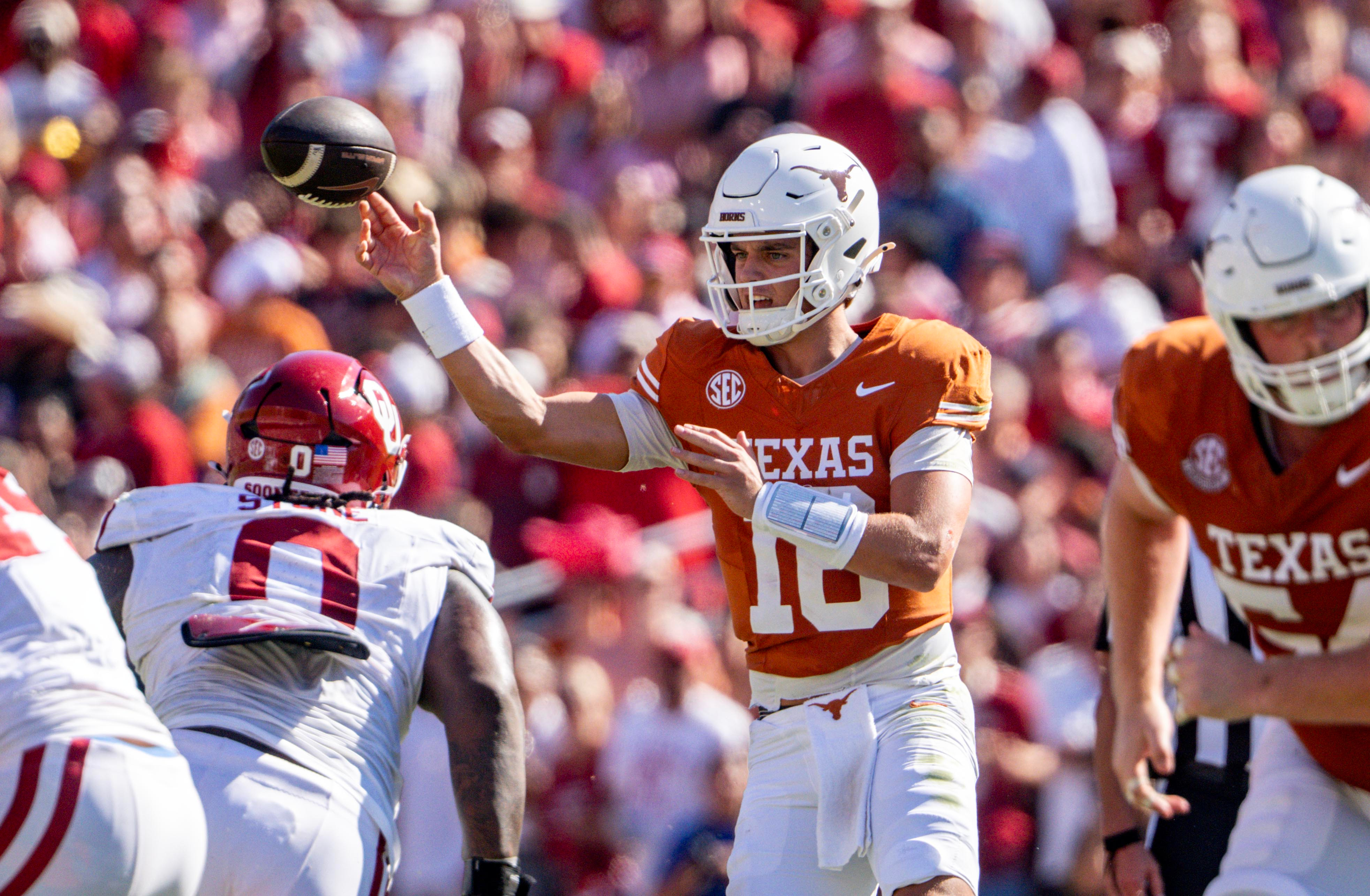 Texas quarterback Arch Manning, center, throws a pass during the first half of an NCAA college football game against Oklahoma, Saturday, Oct. 11, 2025, in Dallas. 