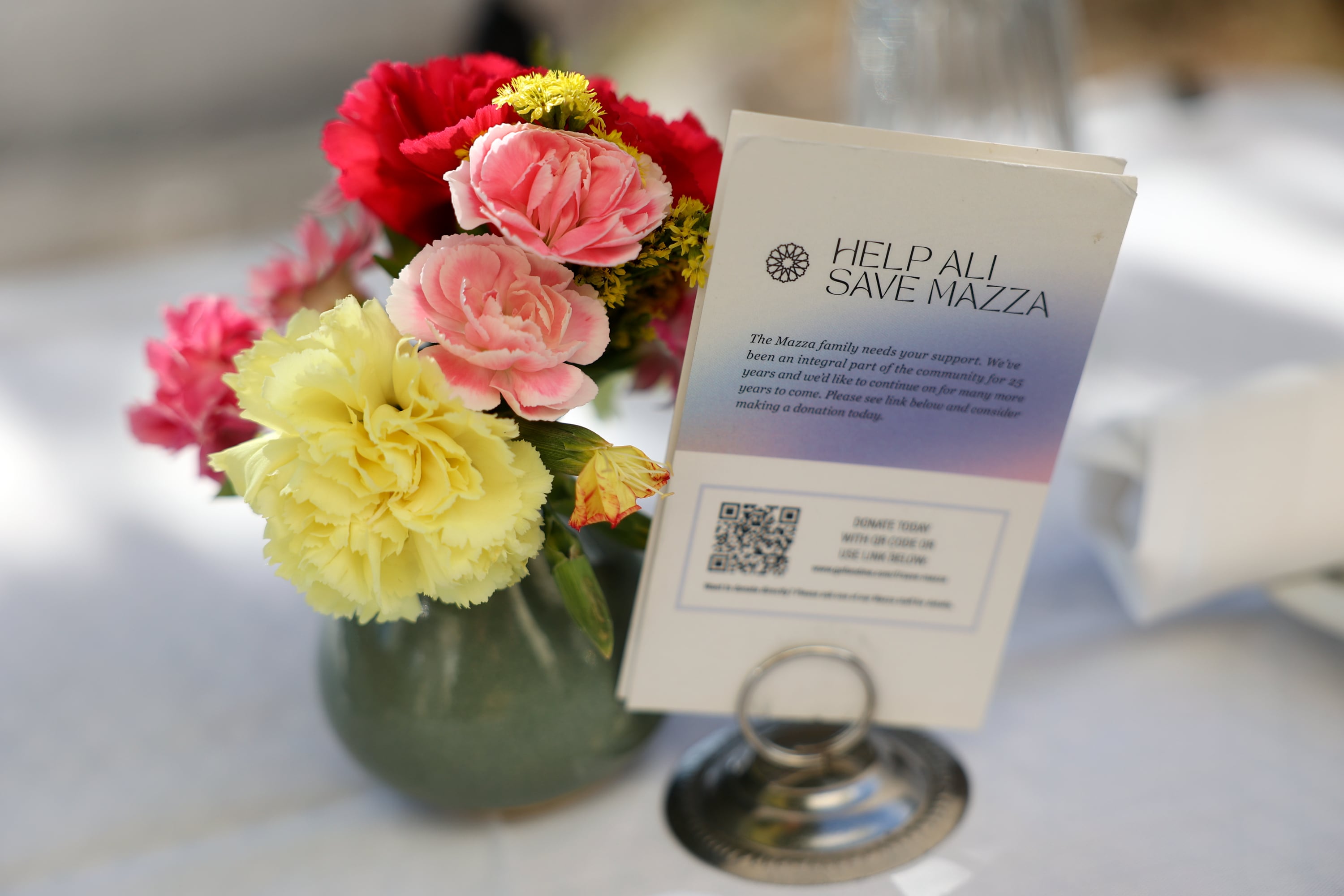 A “Help Ali Save Mazza” sign is pictured on a table at Mazza in Salt Lake City on Sept. 22. The 15th and 15th location is the last one after the 9th and 9th and Sandy locations closed down.