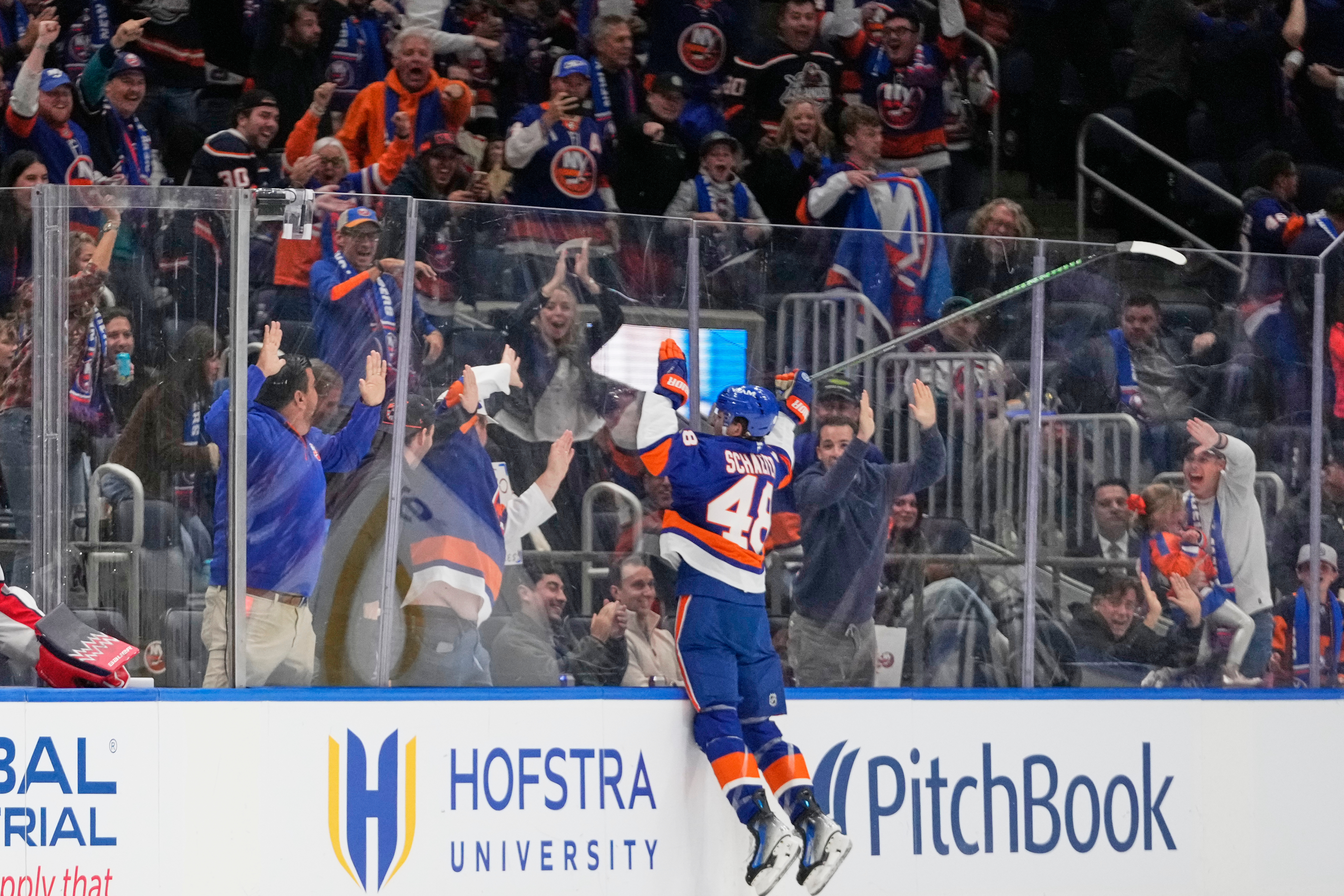New York Islanders' Matthew Schaefer (48) celebrates after scoring his first NHL goal during the third period of an NHL hockey game against the Washington Capitals Saturday, Oct. 11, 2025, in Elmont, N.Y.