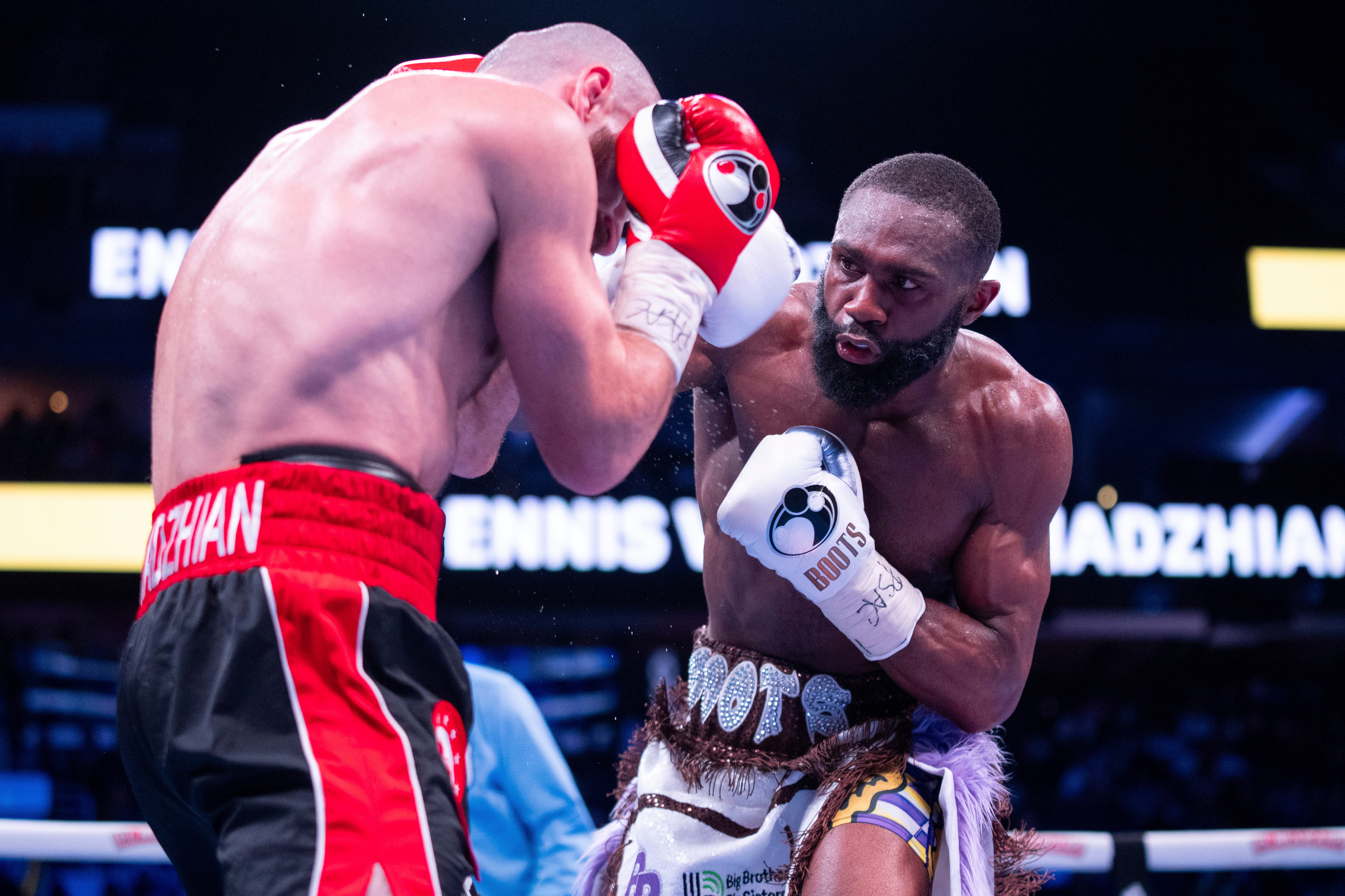 FILE - Jaron Ennis, right, throws a punch at Karen Chukhadzhian, left, during the ninth round IBF World Welterweight title bout, Nov. 9, 2024, in Philadelphia. 